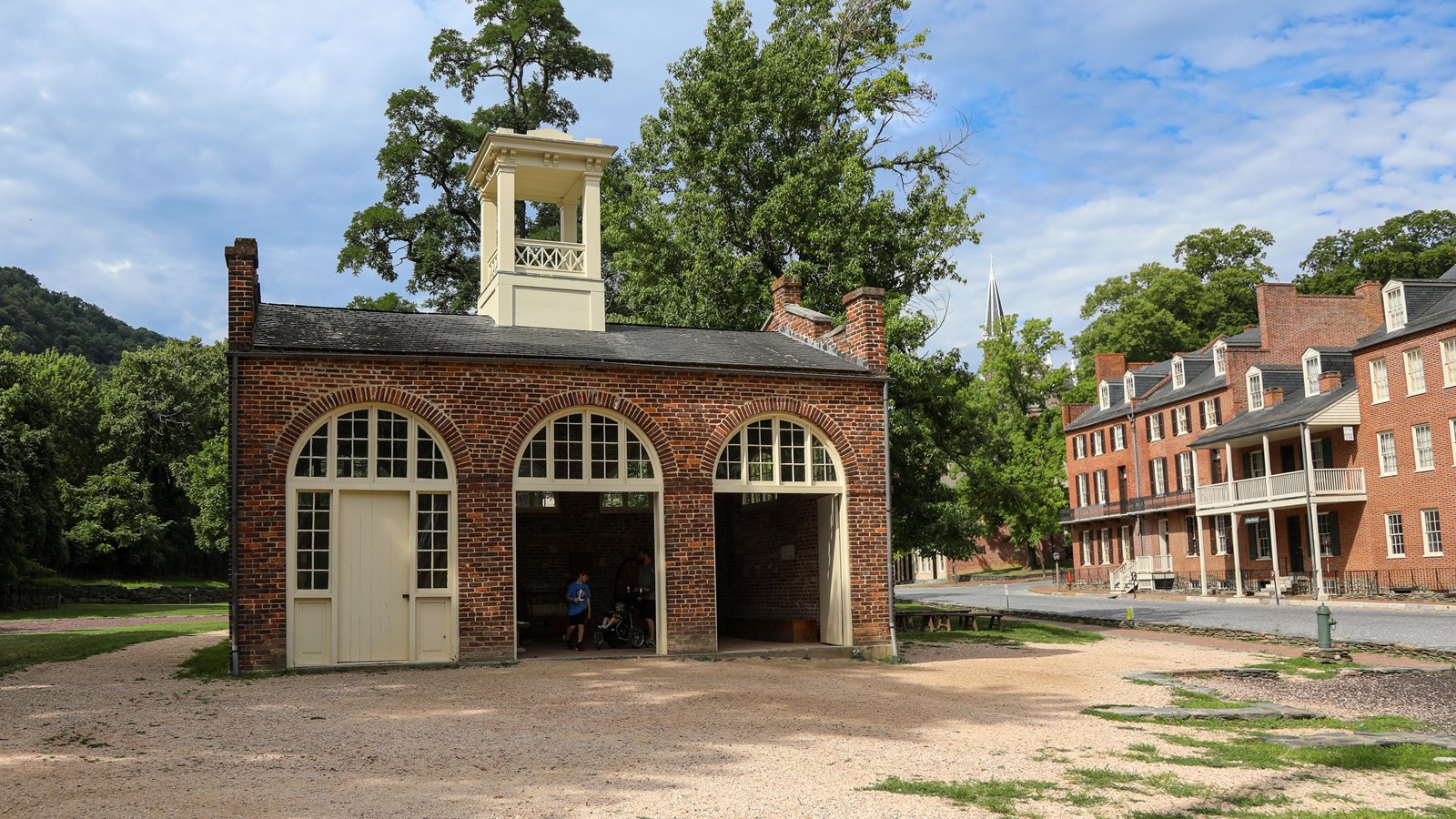 1-story brick building with 3 arched doorways, large enough for historic fire engine