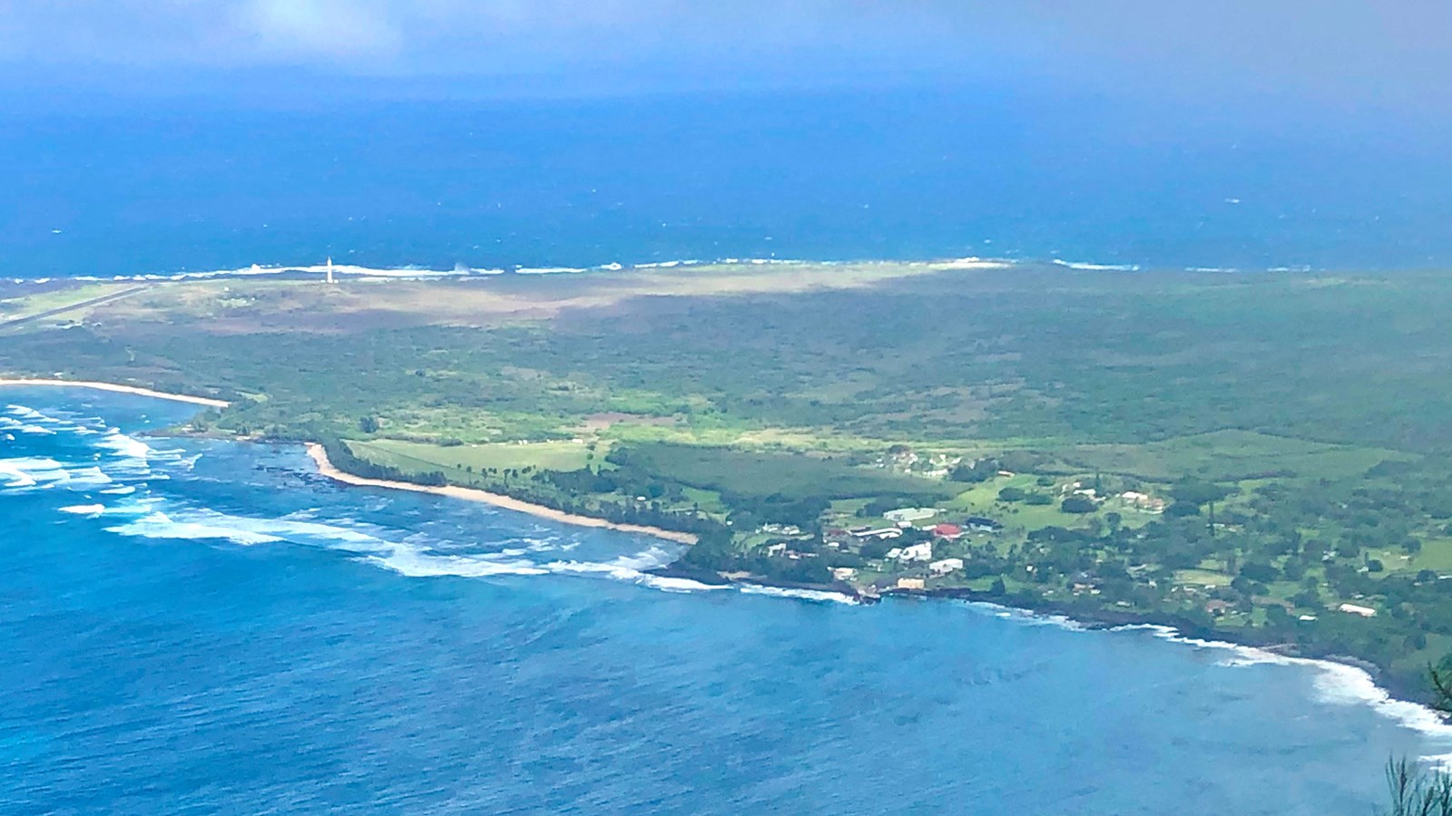 A flat peninsula sticks out into the ocean. 