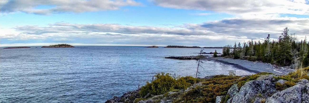 a view of the rocky Rock Harbor shoreline from the edge of the Stoll Memorial Trail