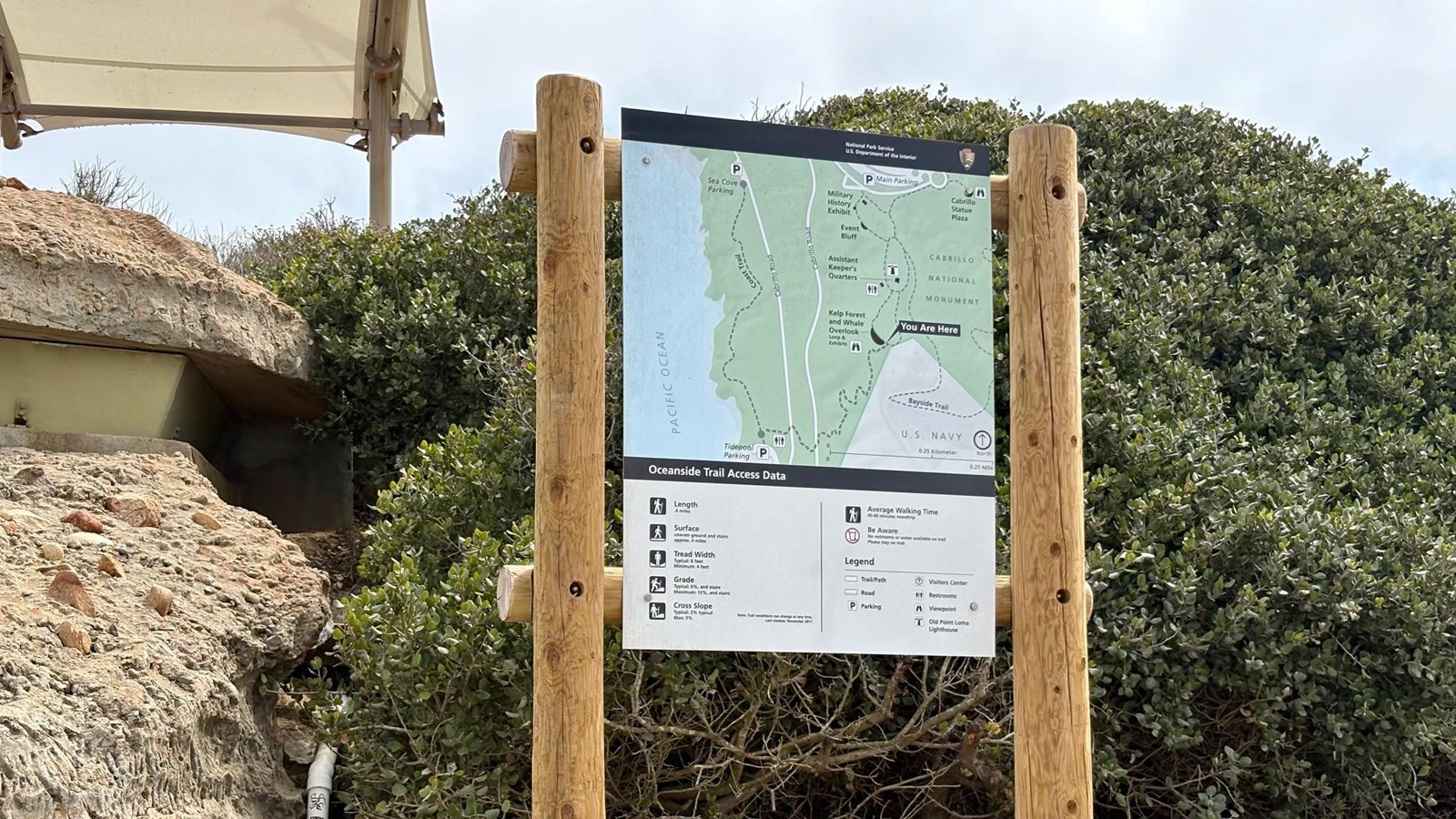 A trailhead sign on a hill