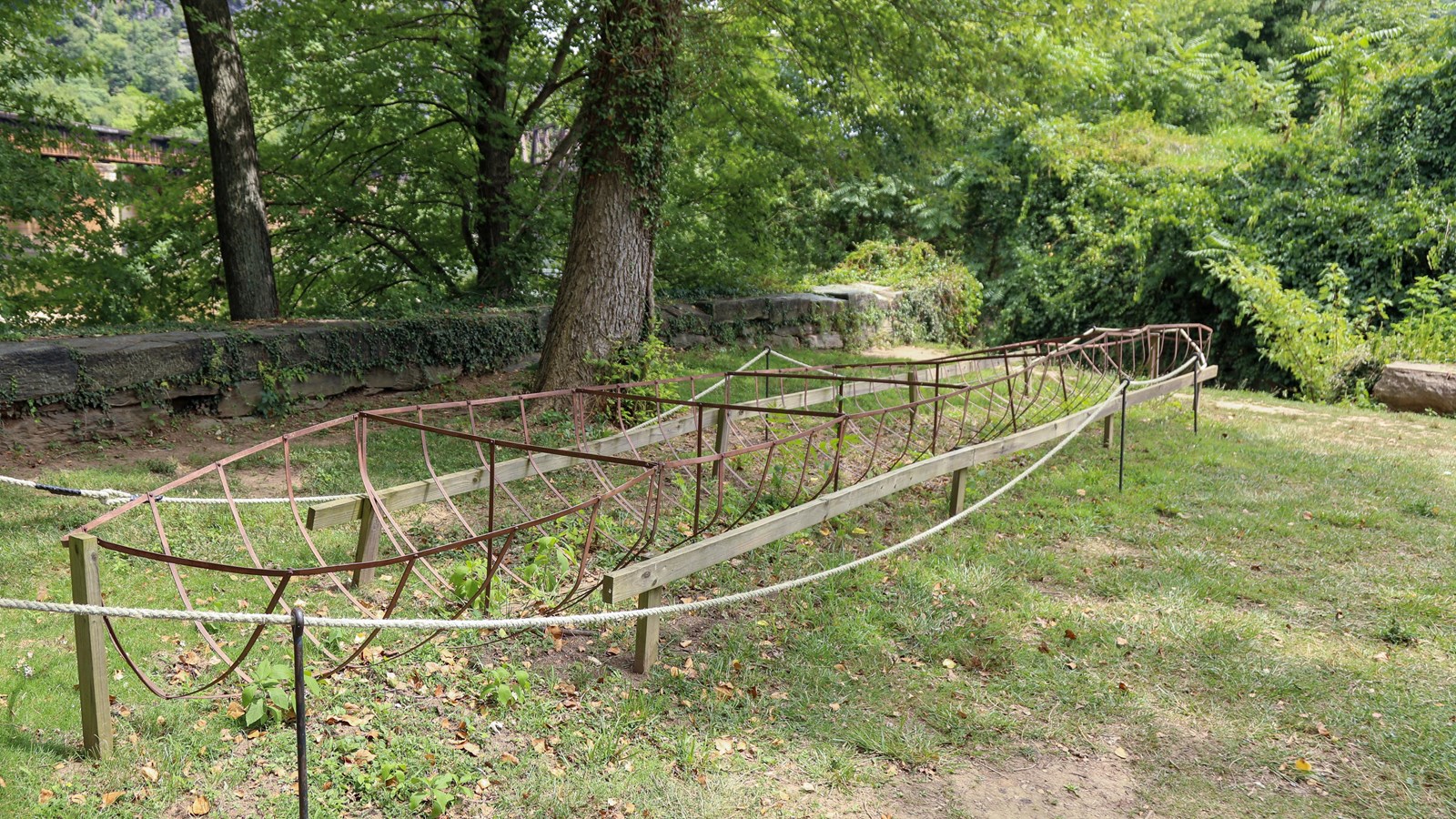 Skeleton of iron paddle boat on ground outside