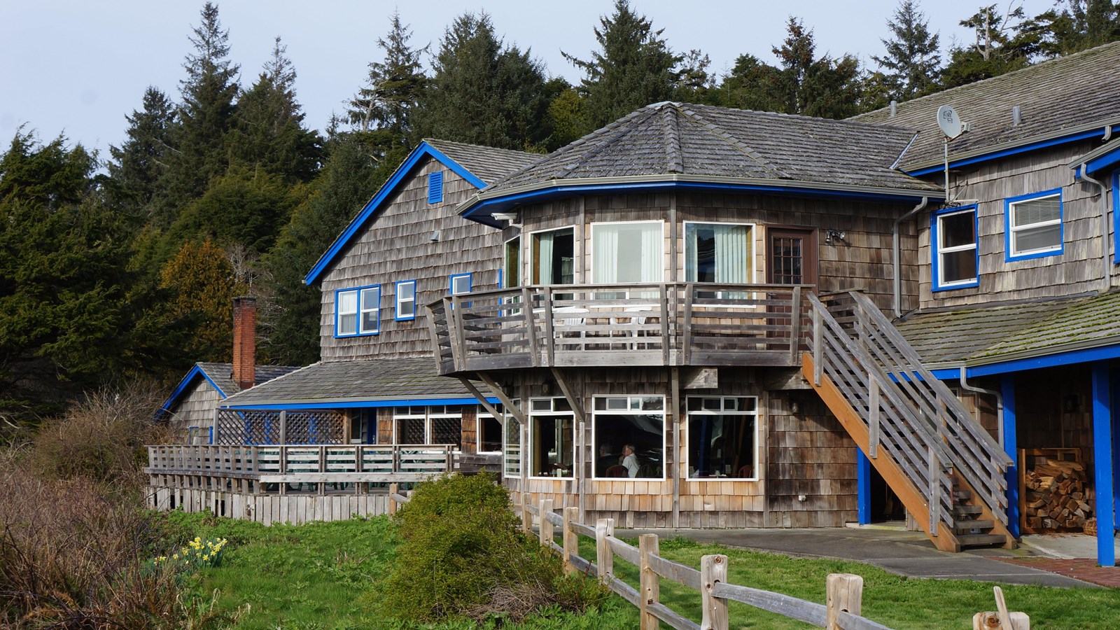 A lodge building with wooden shingles on a bluff.