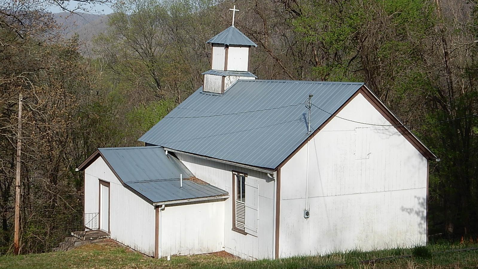 old church sits on a forested hillside
