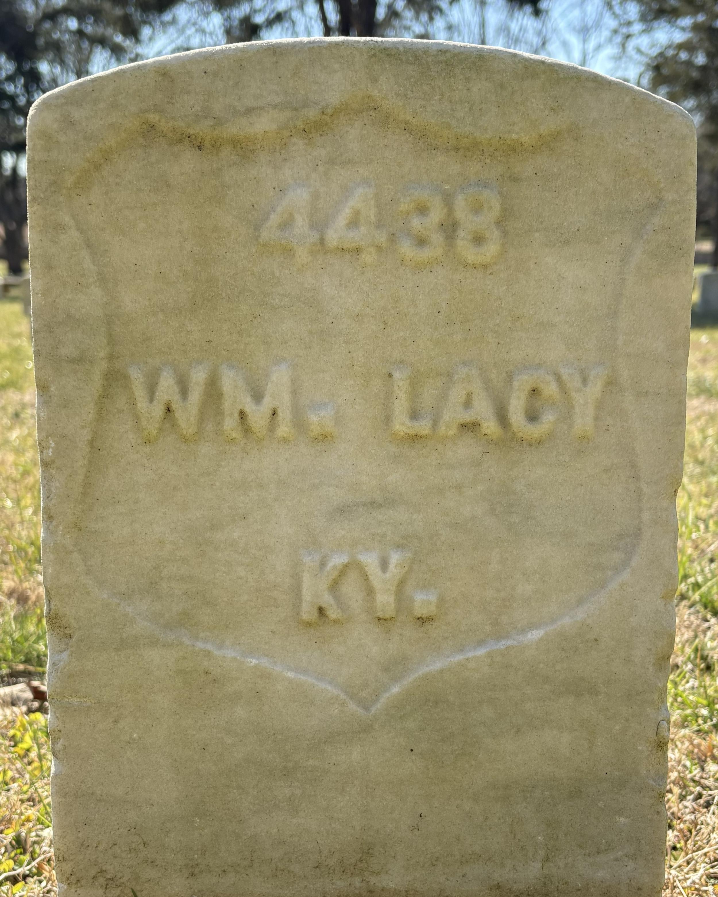 Marble headstone reading "WM Lacy."