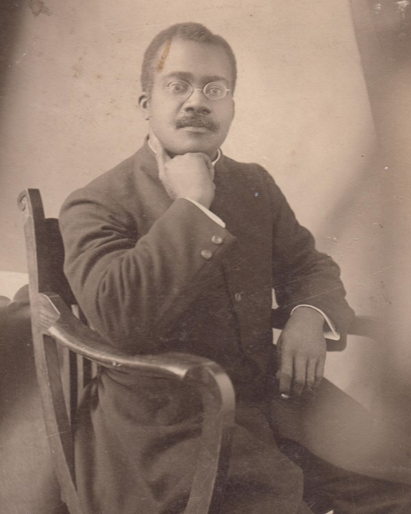 man sitting in a chair for a portrait