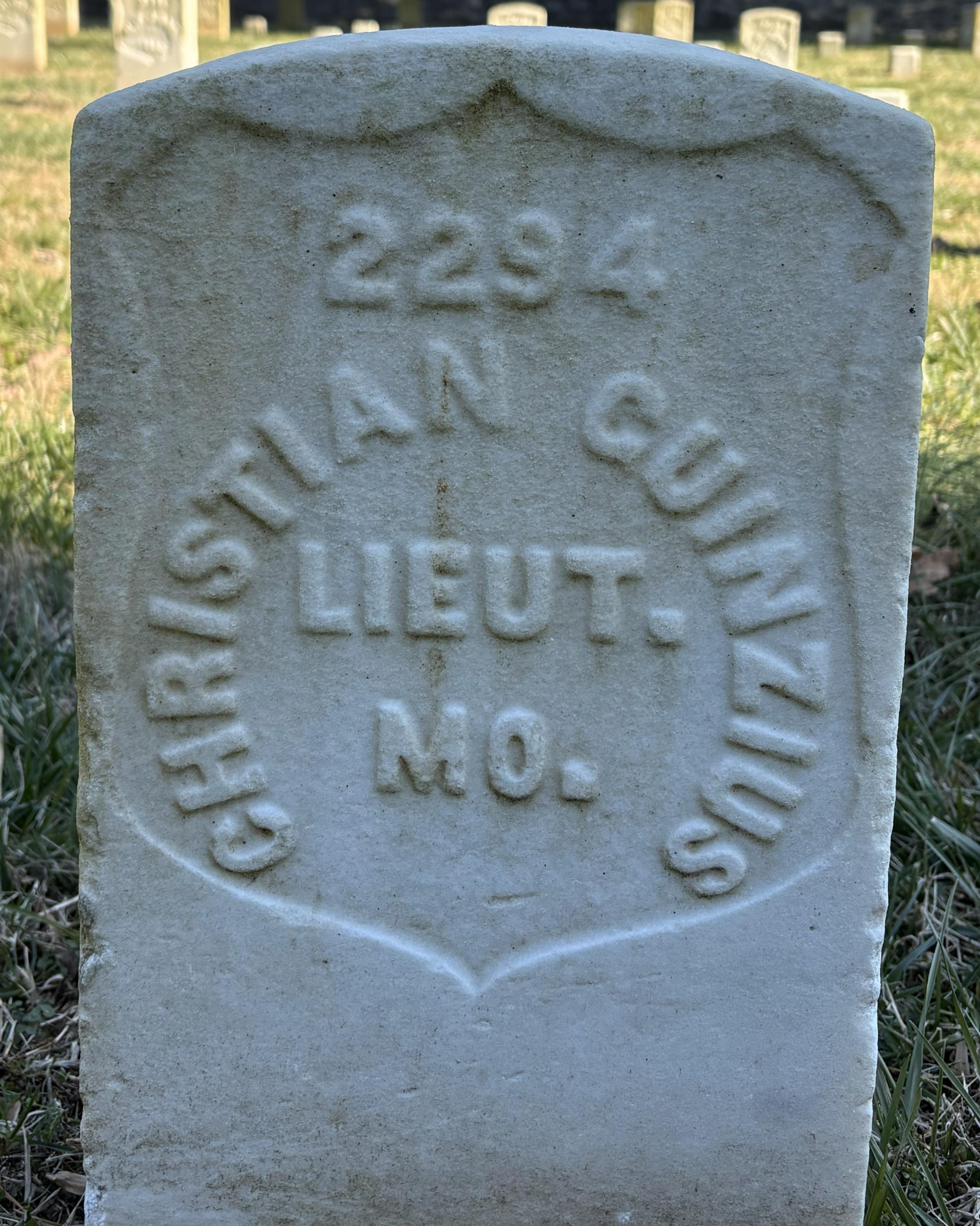 Marble headstone belonging to Christian Guinzius located in the Stones River National Cemetery.