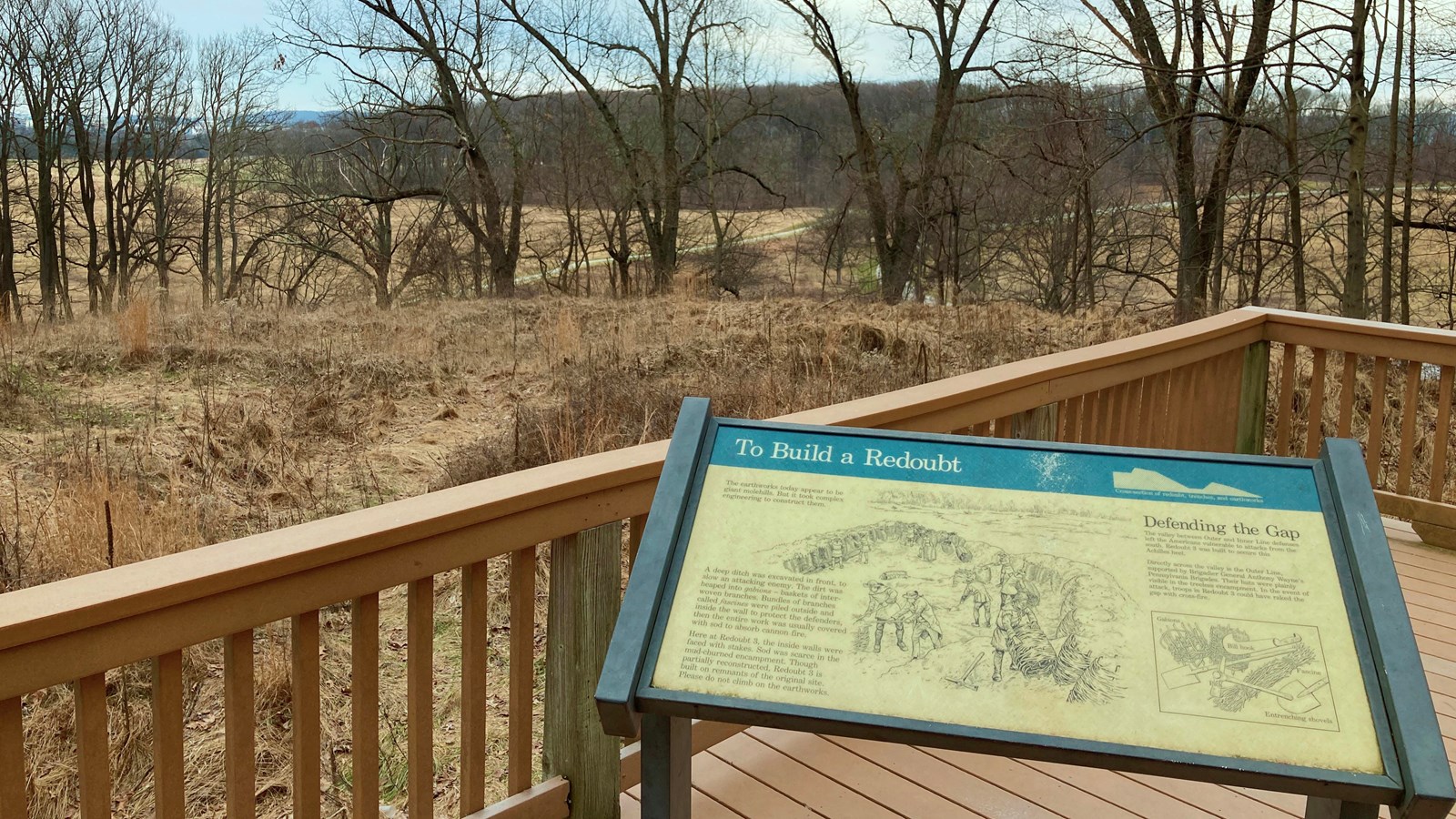 outdoors, trees, grass, earthworks, sign, railing