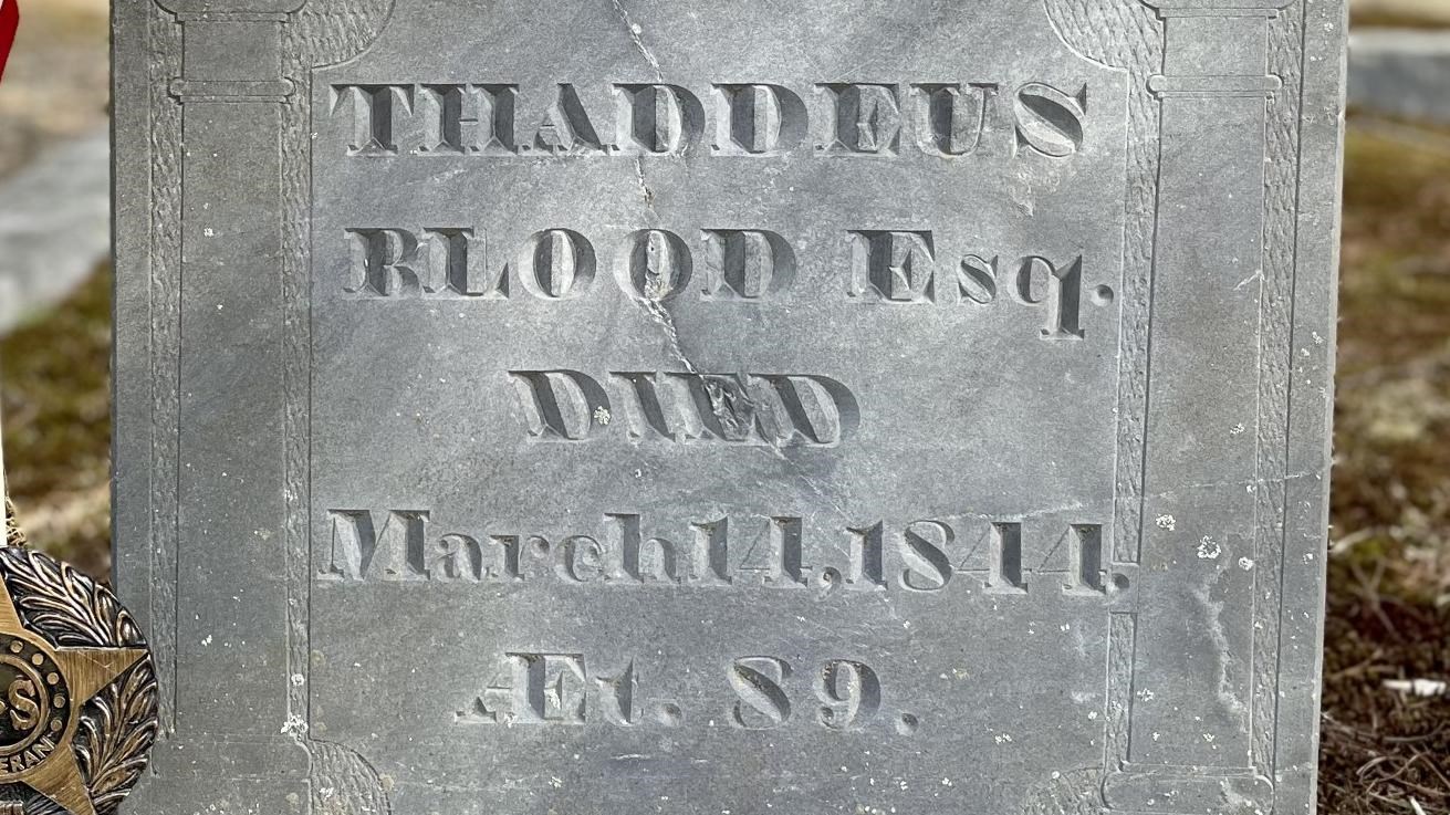 A large slate gravestone with the words Thaddeus Blood Esq. Died March 11, 1844