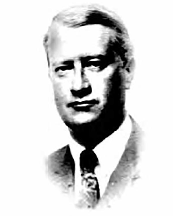 A head and shoulders portrait of a man wearing a coat and tie.