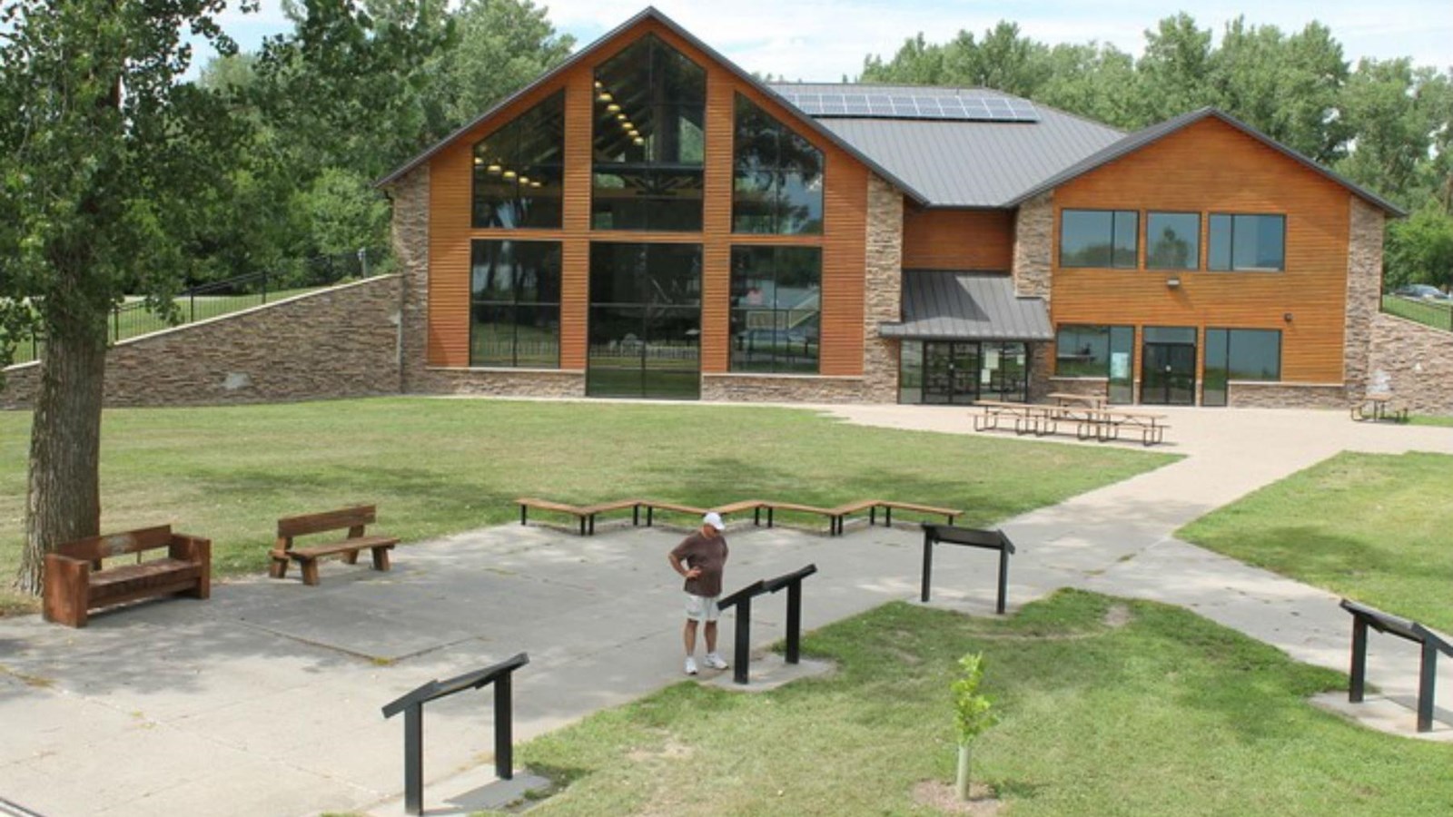 visitor center building with interpretive signs in the foreground