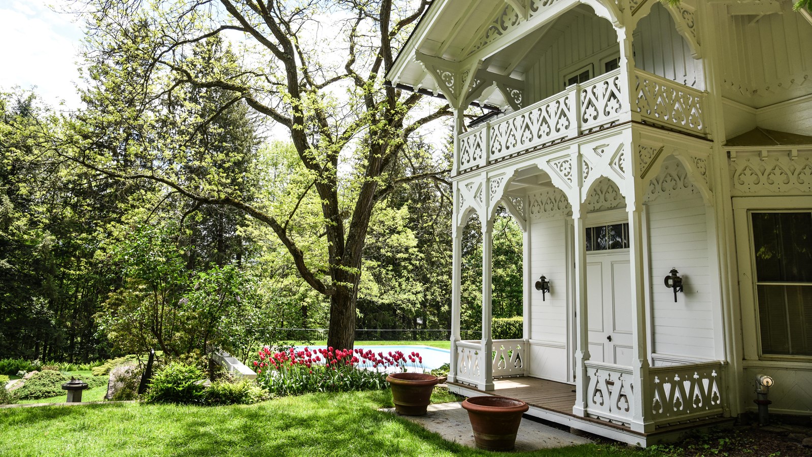 white building reminiscent of a Swiss cottage surrounded by flowers