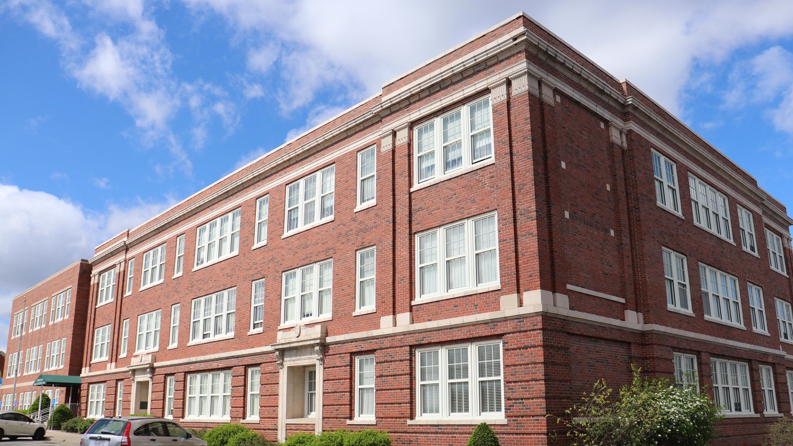 A corner view of a three story brick building.
