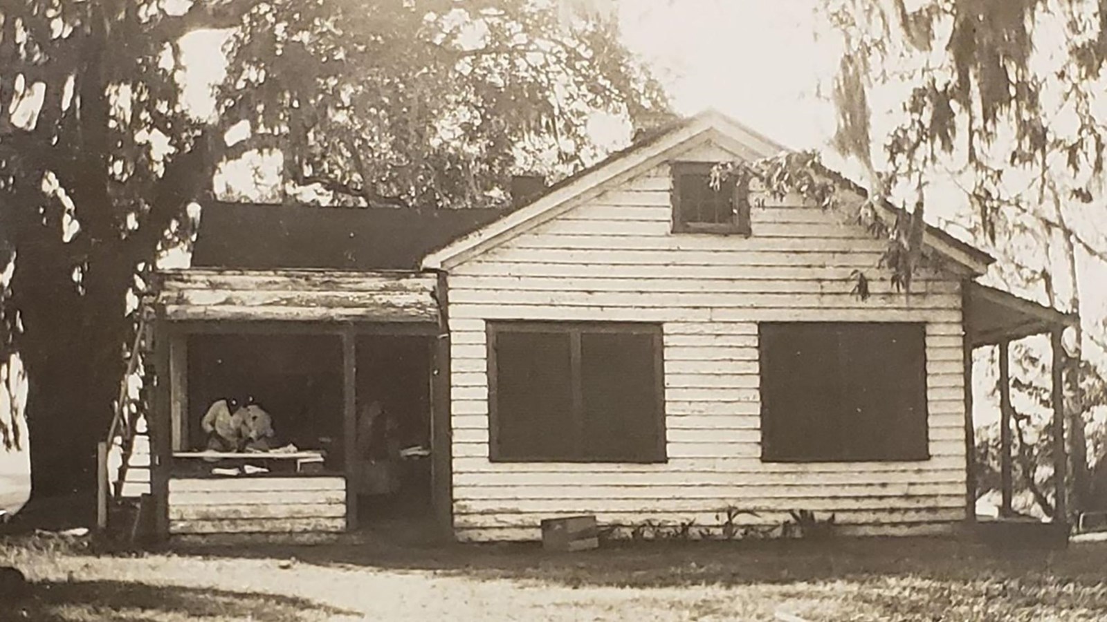 A single-story white building with porch.