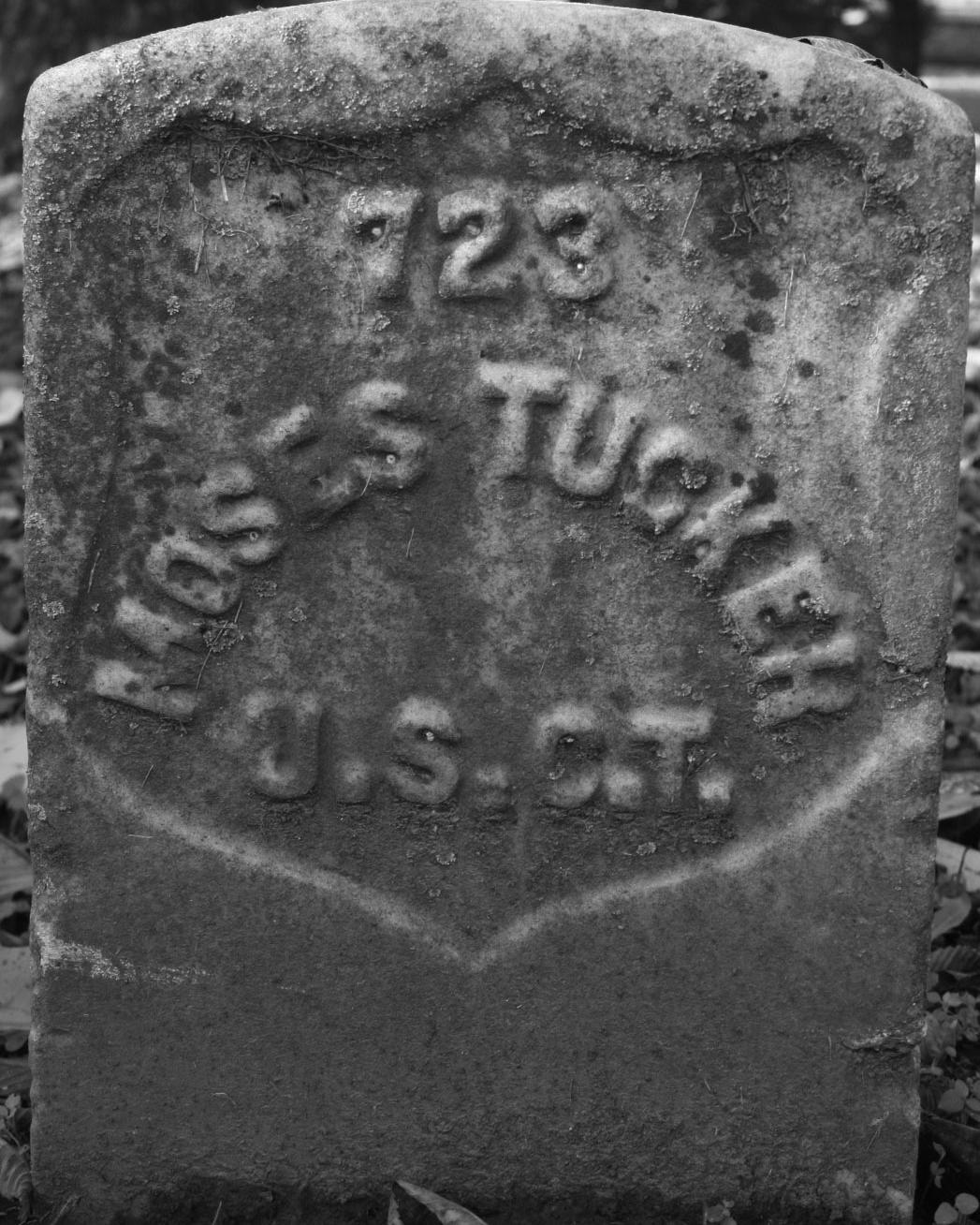 Marble headstone in black and white representing Moses Tucker's burial site. 