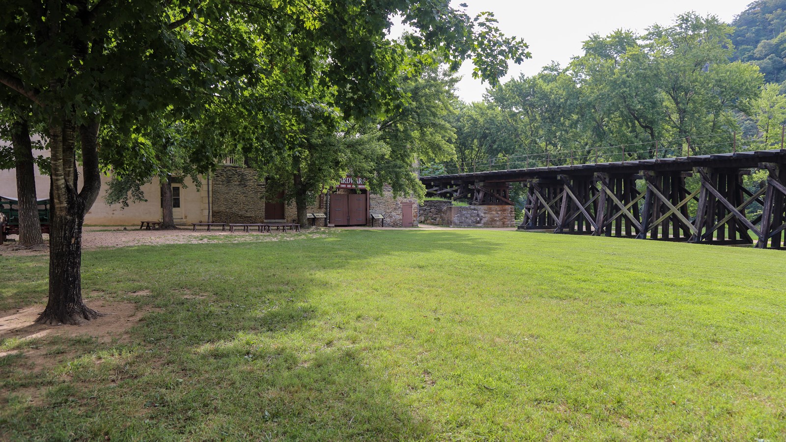 A green lawn in front of a railroad track