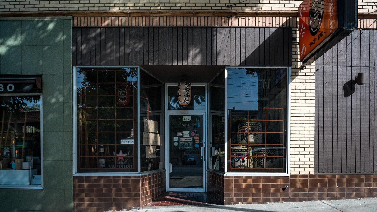 Exterior of a street-level storefront in an urban setting.