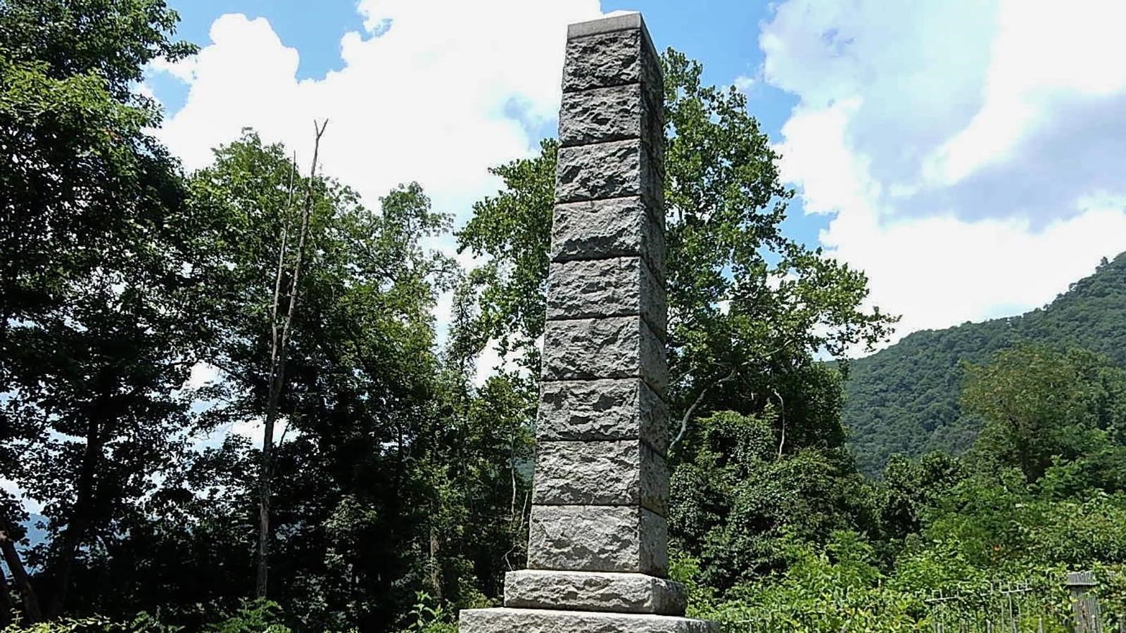 granite monument in a forested setting