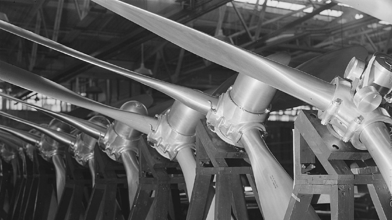 large shaped metal columns or propellers stand in a row