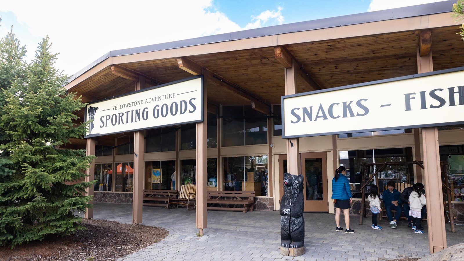 A building with a large porch and a sign that says, 