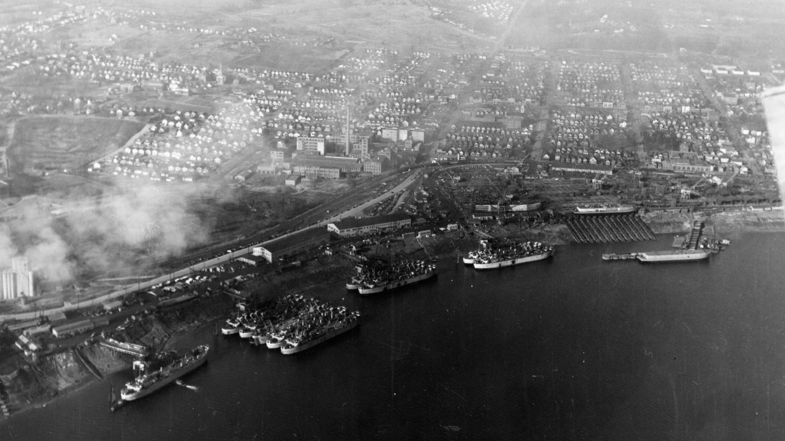 ships lined up side-by-side in rows in water on the columbia river