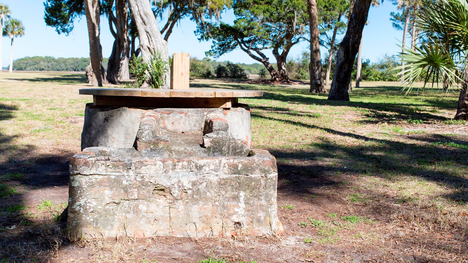 a low circular stone well 