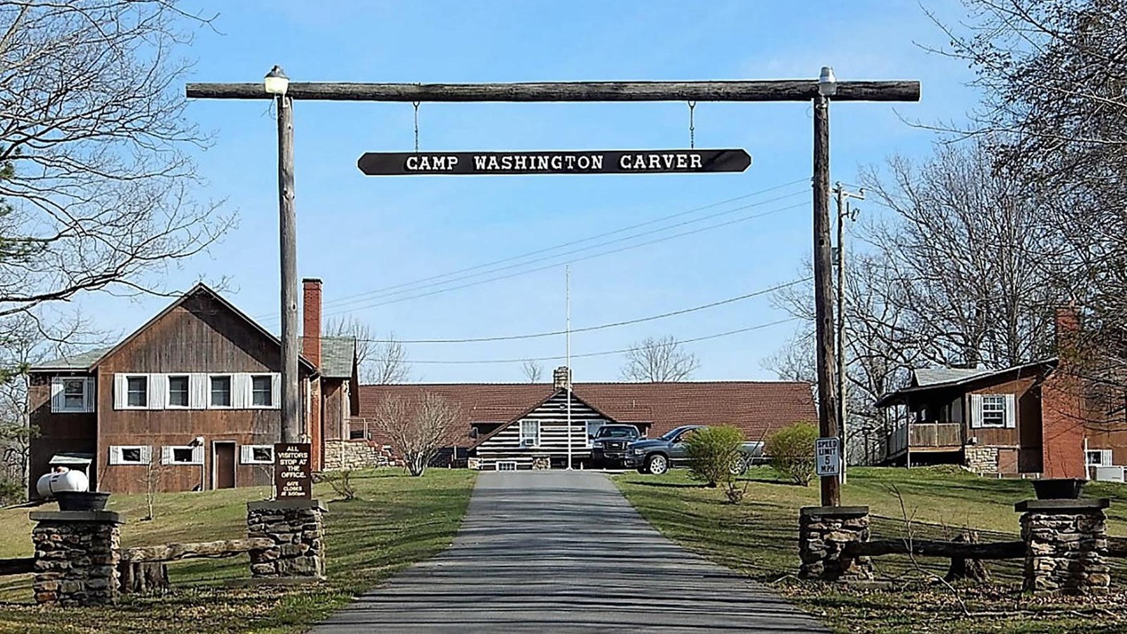 camp lodge with Camp Washington Carver sign over entrance road