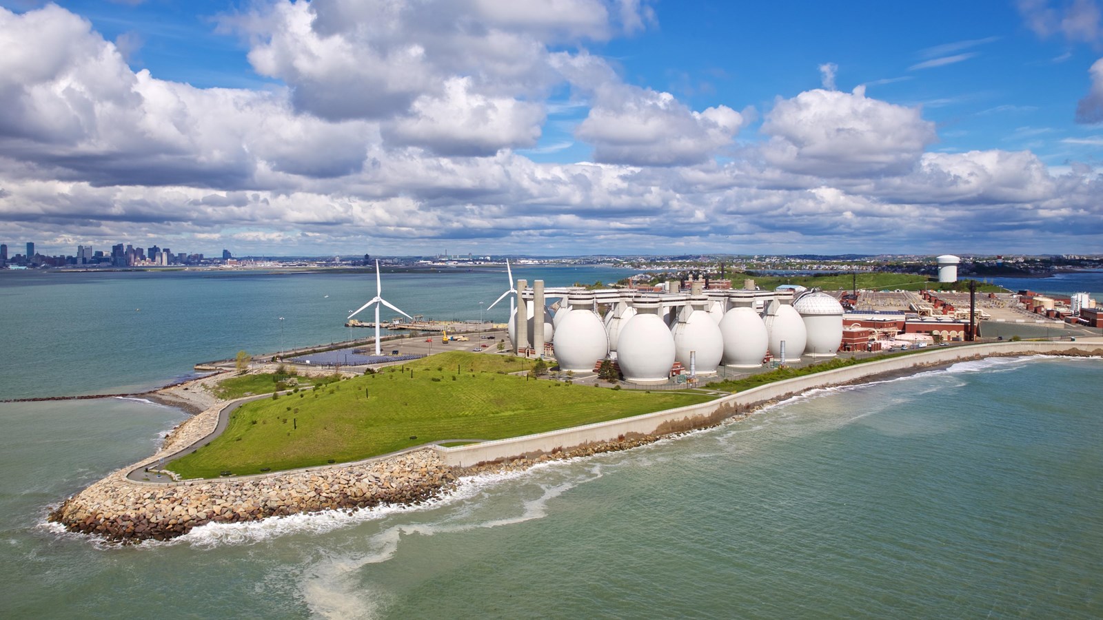 Island with a series of white globes of the wastewater treatment plant.