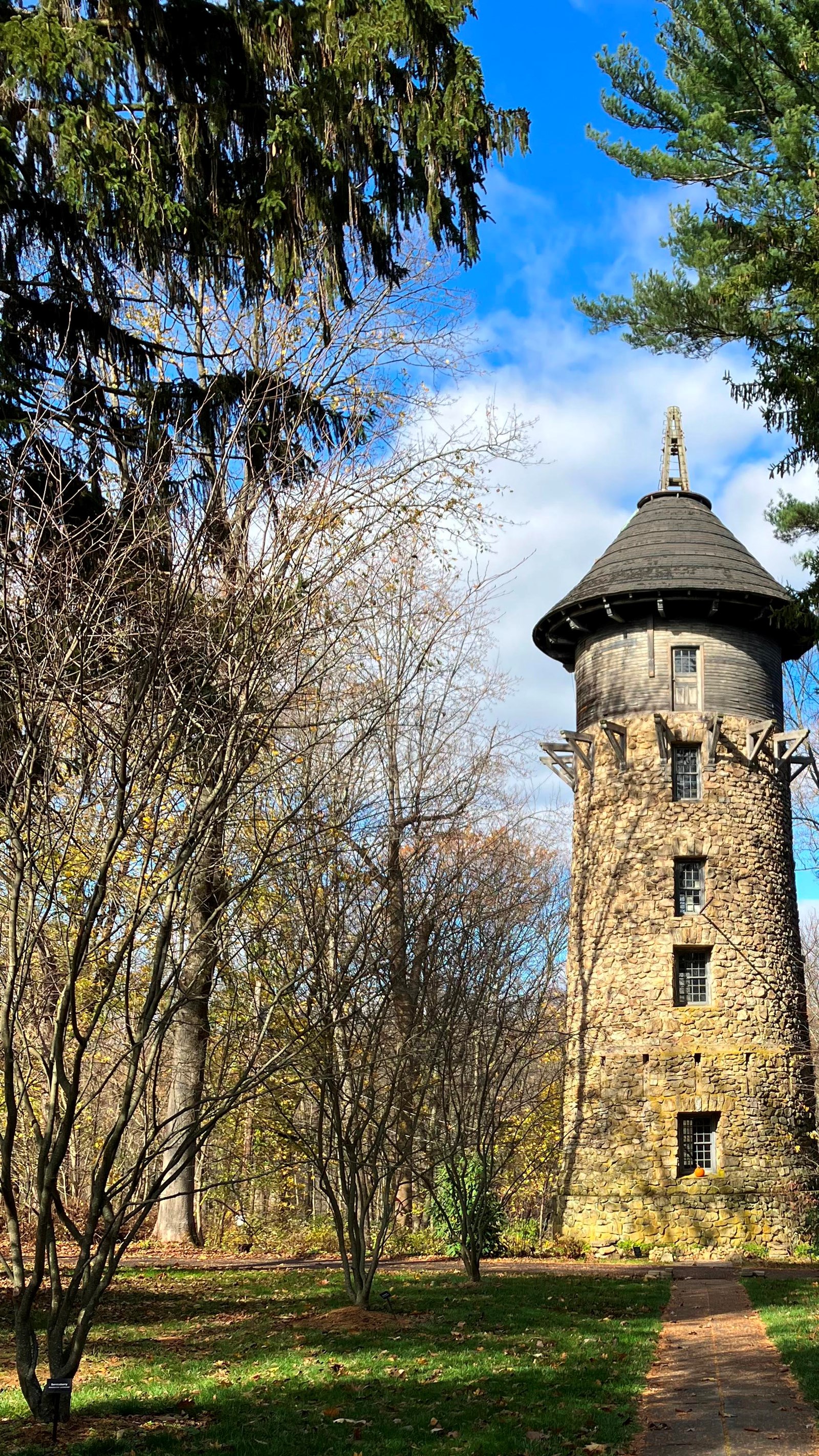 A five story high tower of stone with single column of windows facing the viewer.