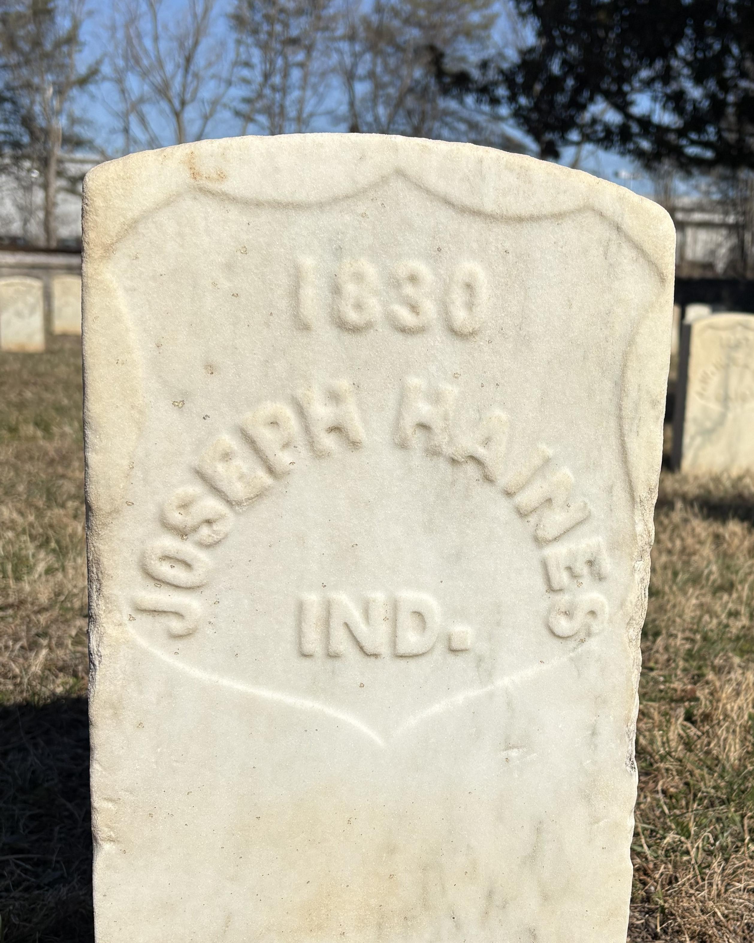 Marble headstone that reads "Joseph Haines."