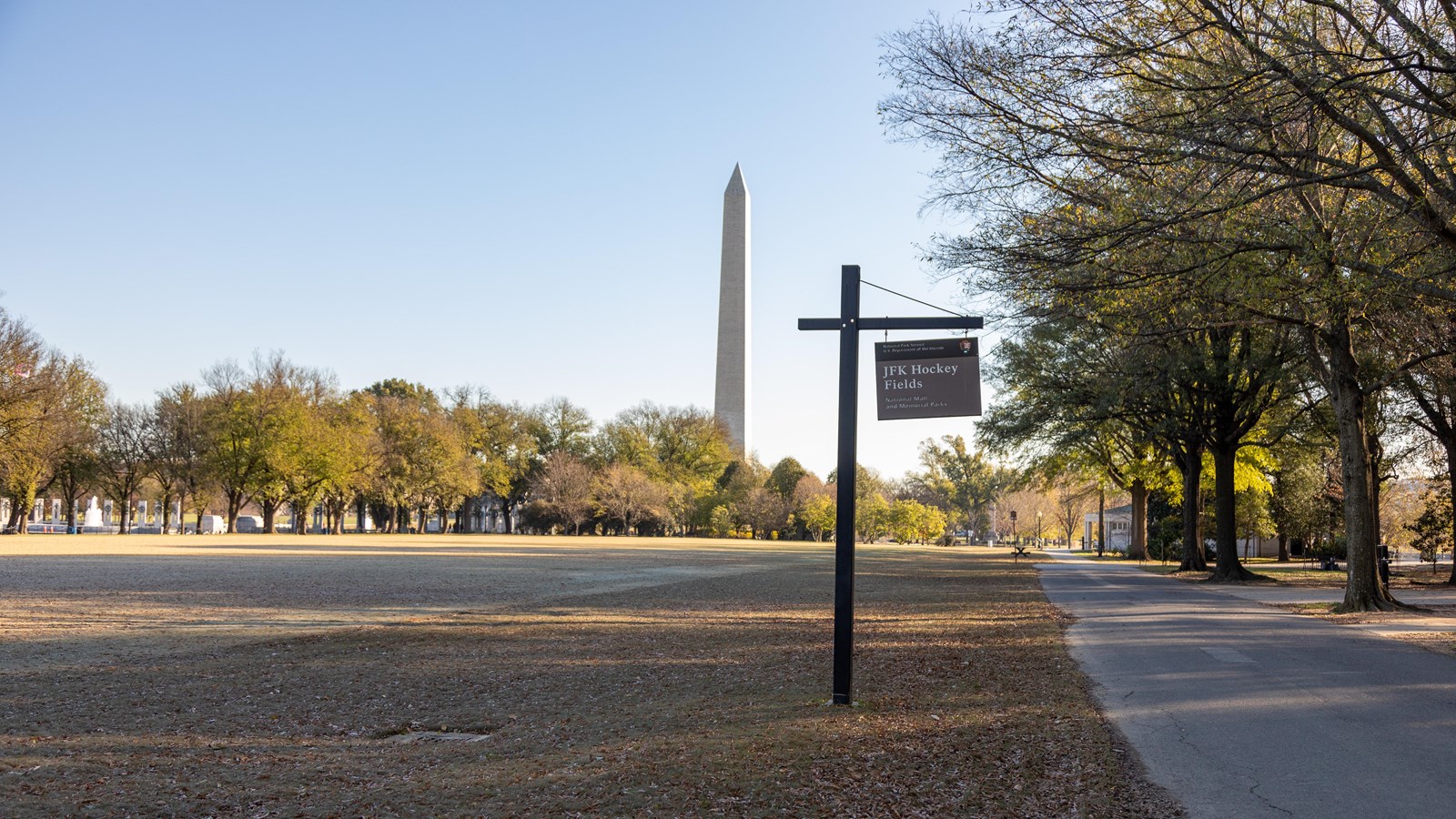 A grass field with a sign 