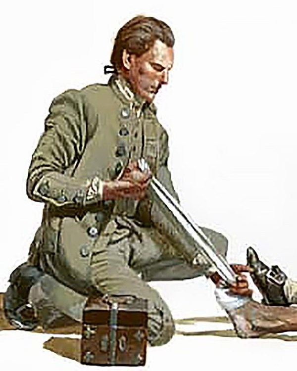 A well dressed man kneels over a person's foot, applying a bandage to it.