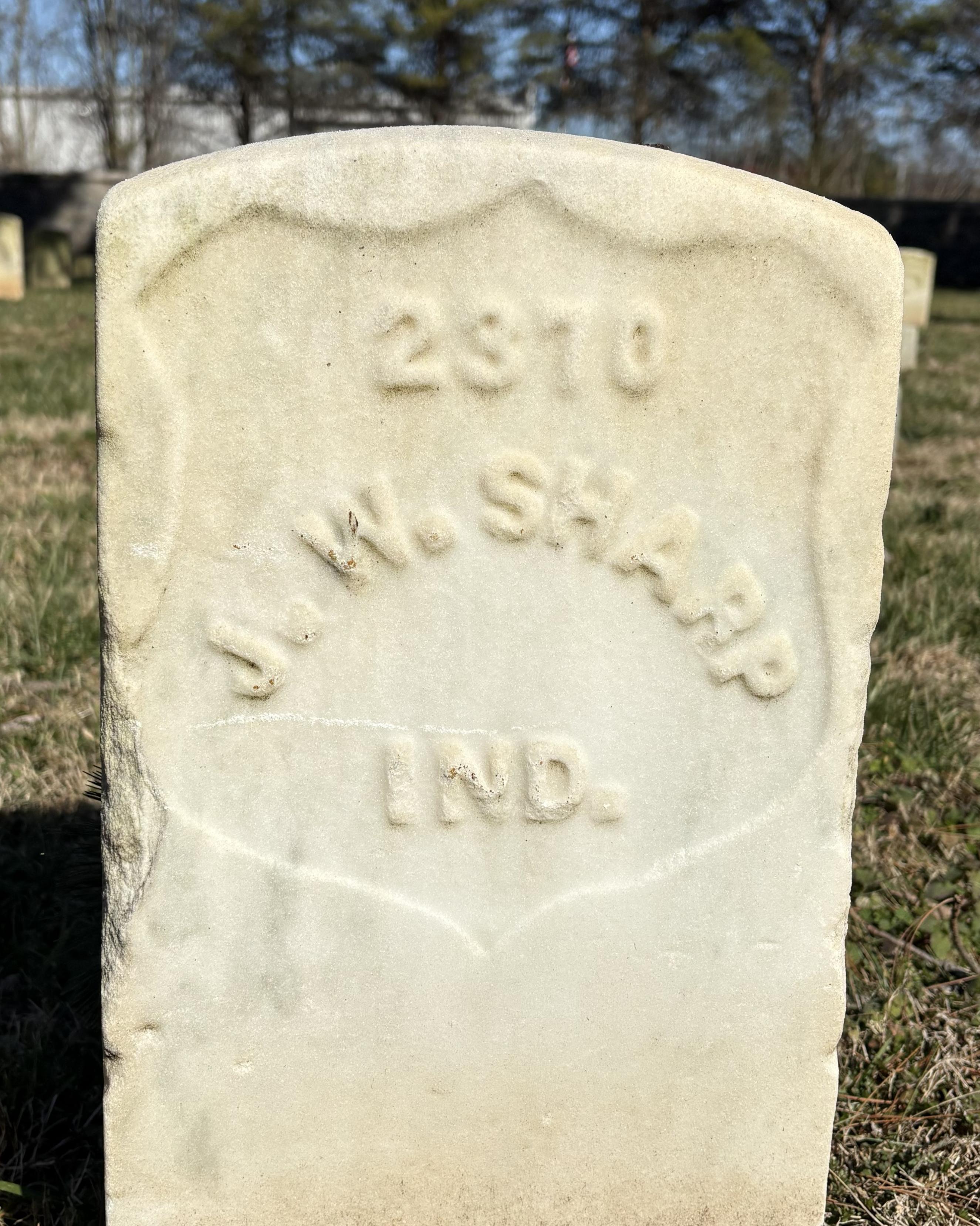 Marble headstone that reads "J. W. Sharp Ind."