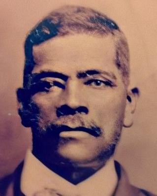 Sepia tone portrait of Randel Farnell in suit with mustache.