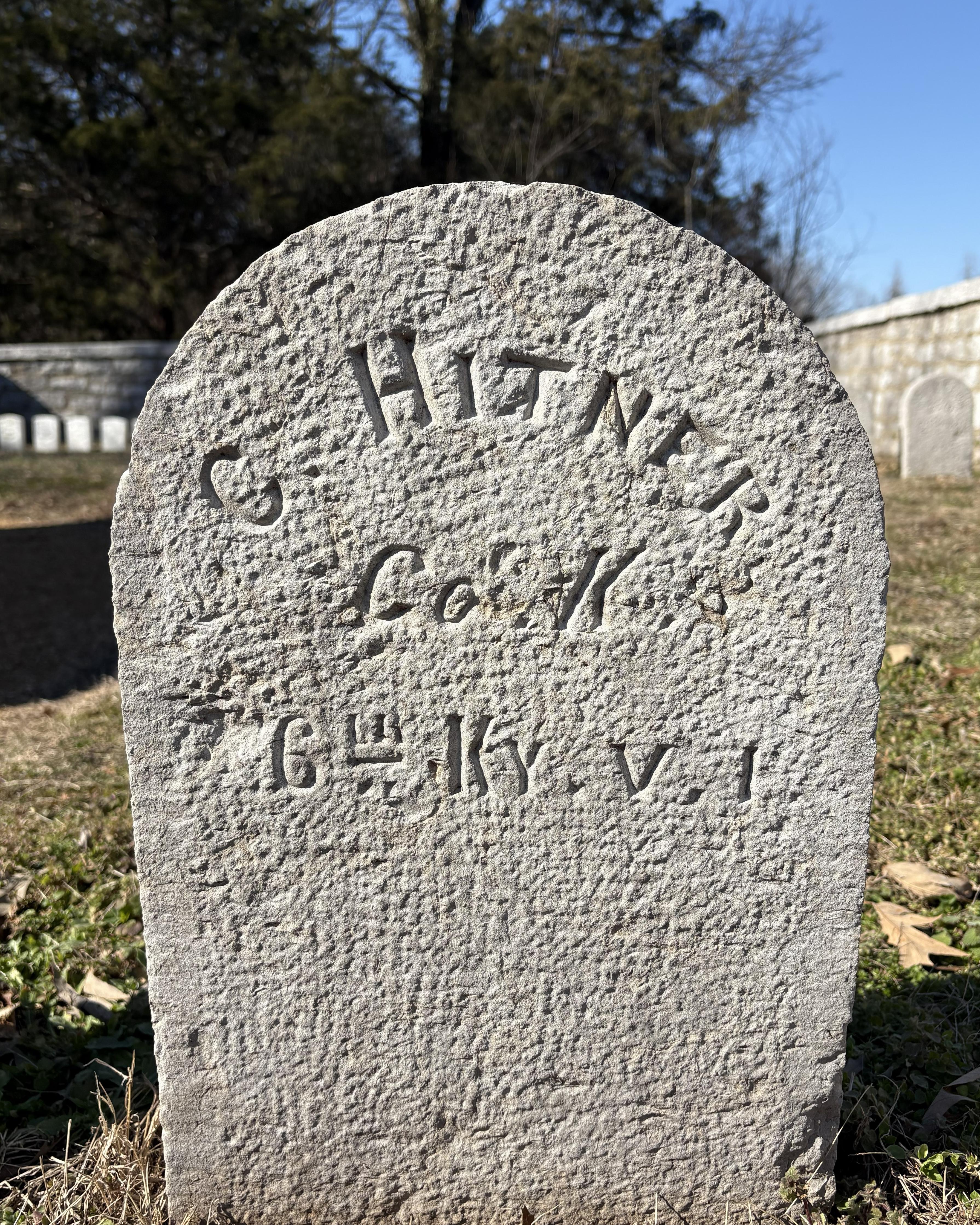 Small headstone with grainy texture that reads "C. Hitner Co. K 6th Ky. V. I."