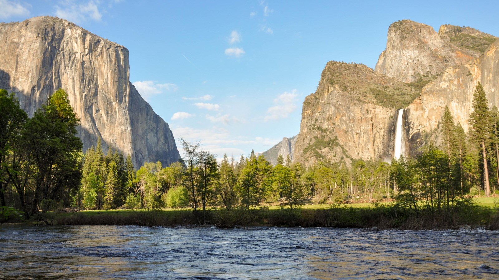 View of El Capitan on the left, the river in the foreground, and Bridalveil Fall on the right