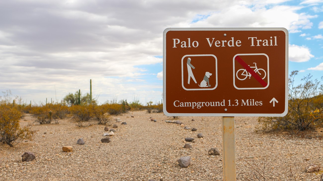 Brown trailhead sign reading