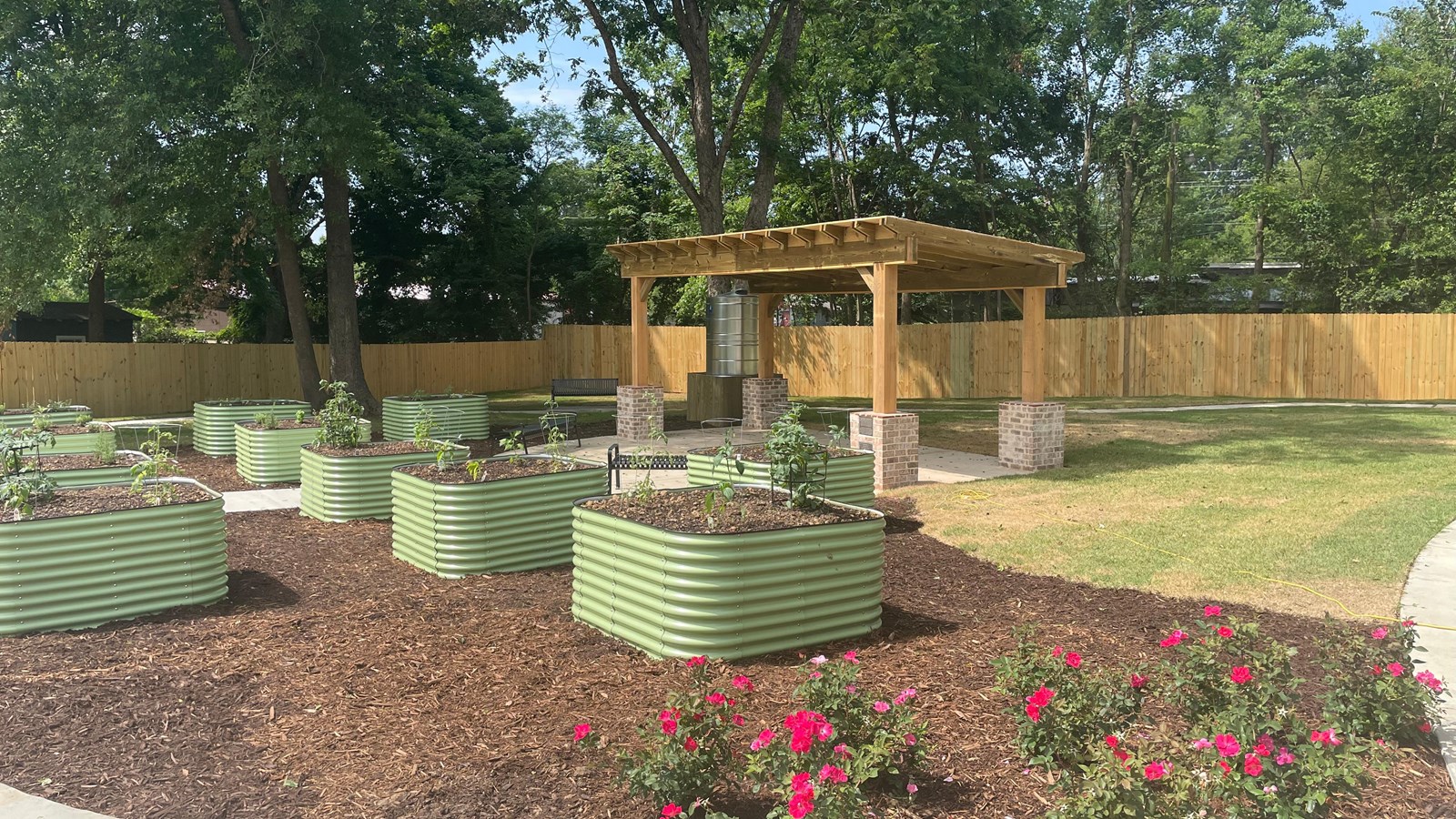 Myrlie\'s Garden site with plantings and a shade structure