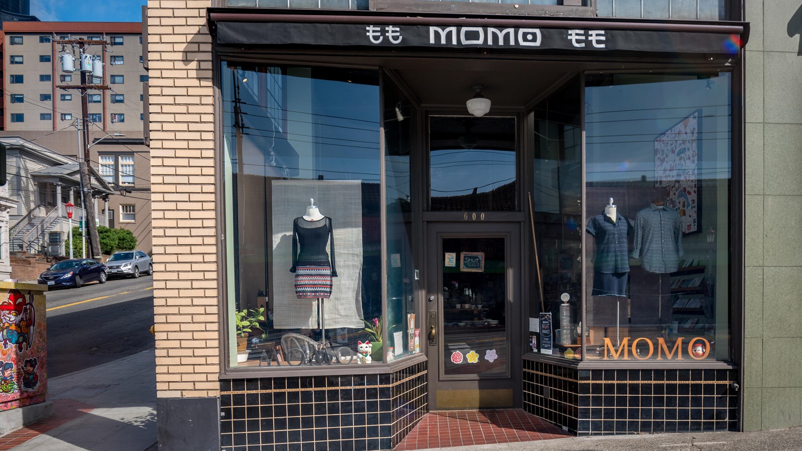 Urban clothing store with large window displays and a distinct sign that reads 
