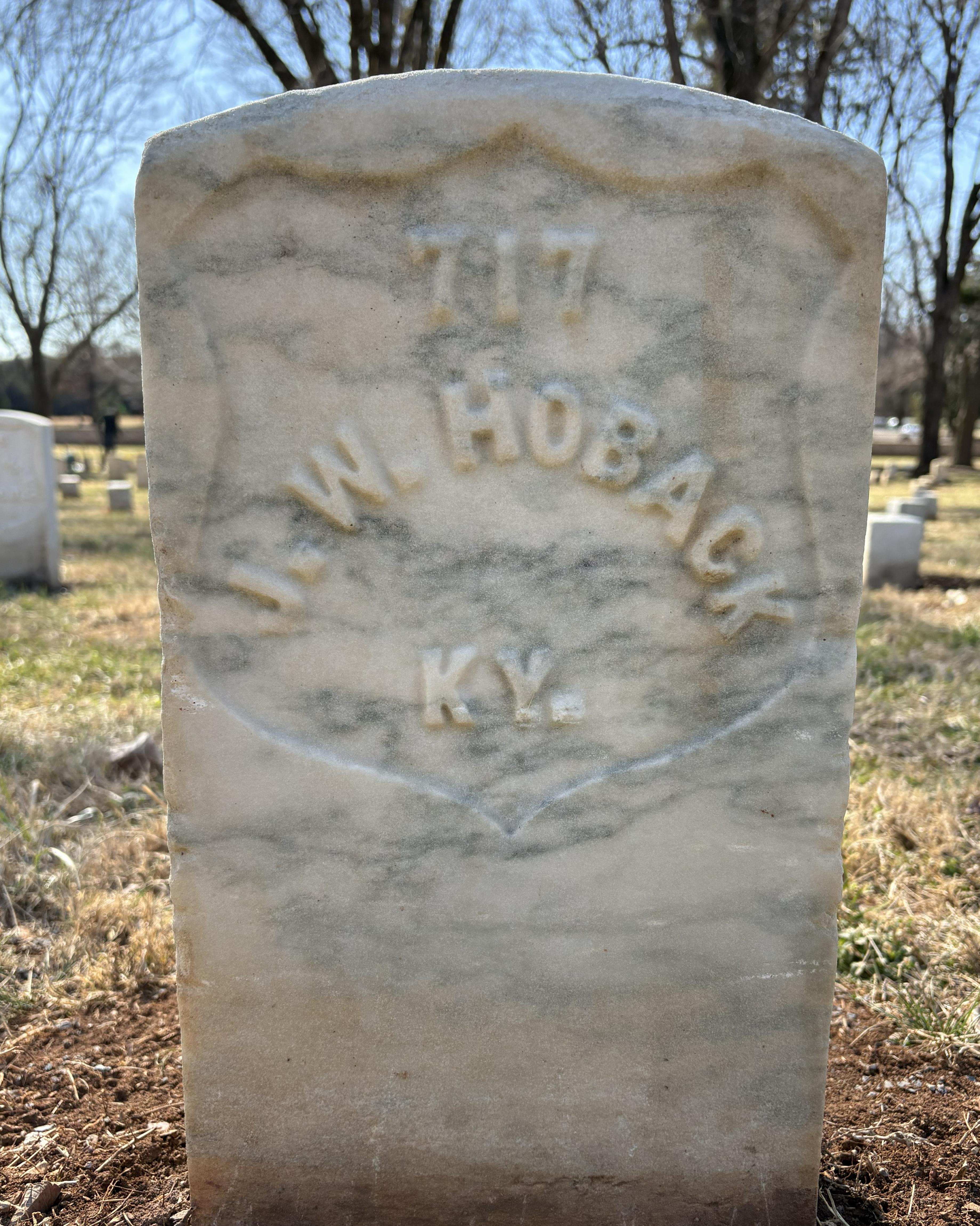 Marble headstone reading "J.W. Hoback"