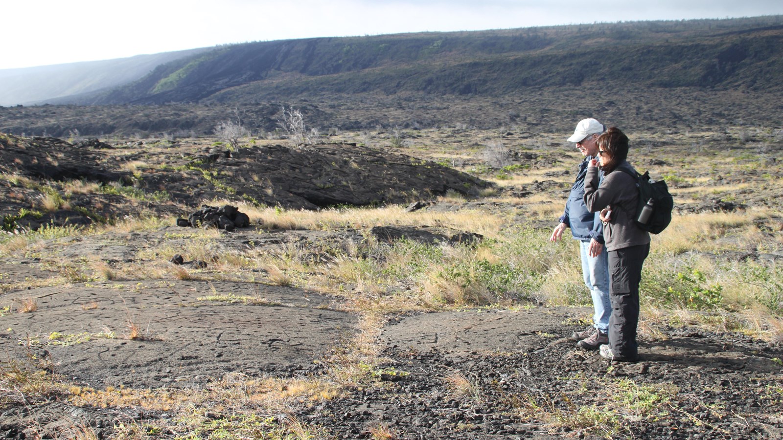 Person walking on a volcanic trail.