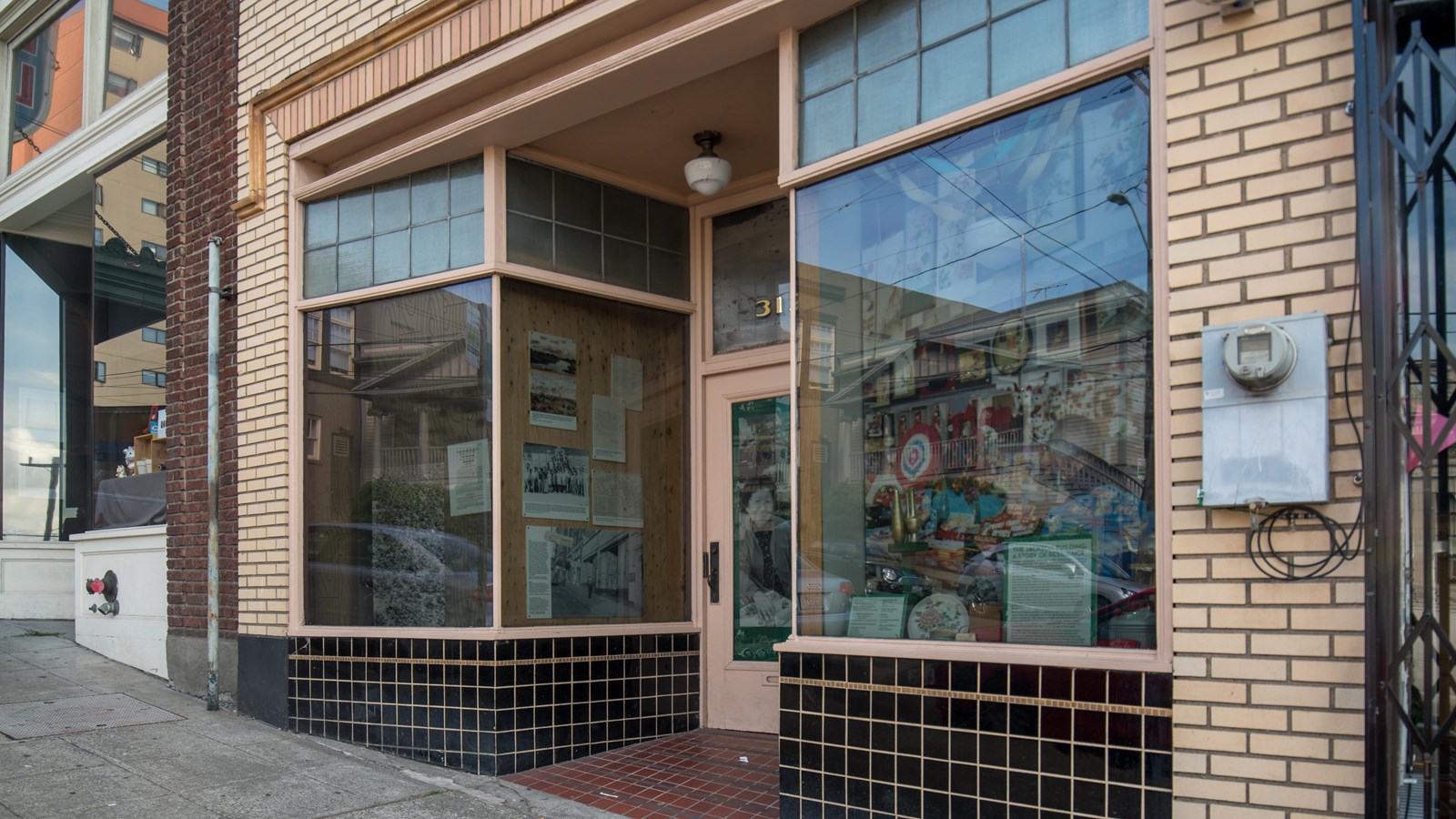 Modestly-sized, old-fashioned storefront that stands out for its architectural details.