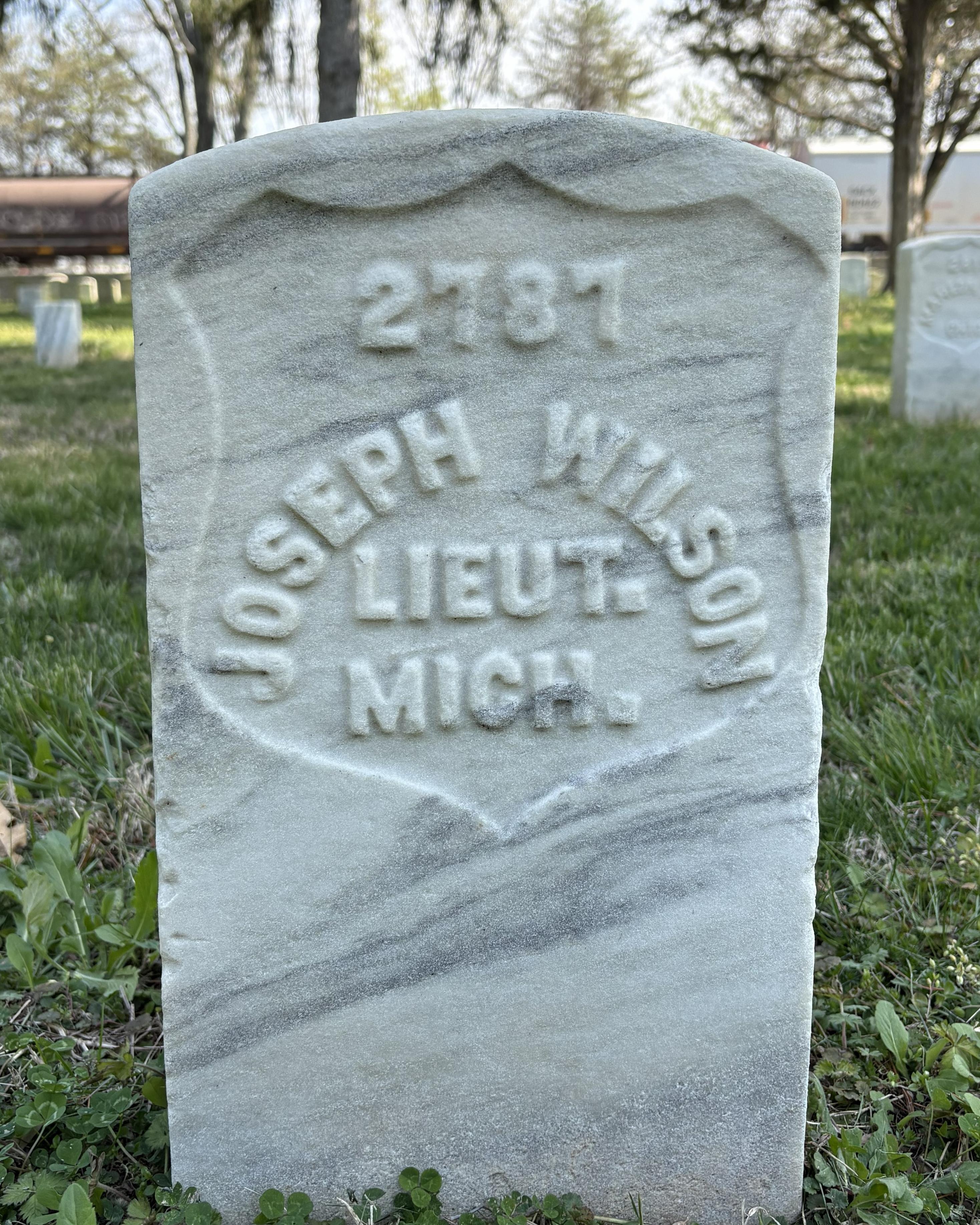 Marble headstone with "Joseph Wilson LIEUT. MICH." inscribed on it. 