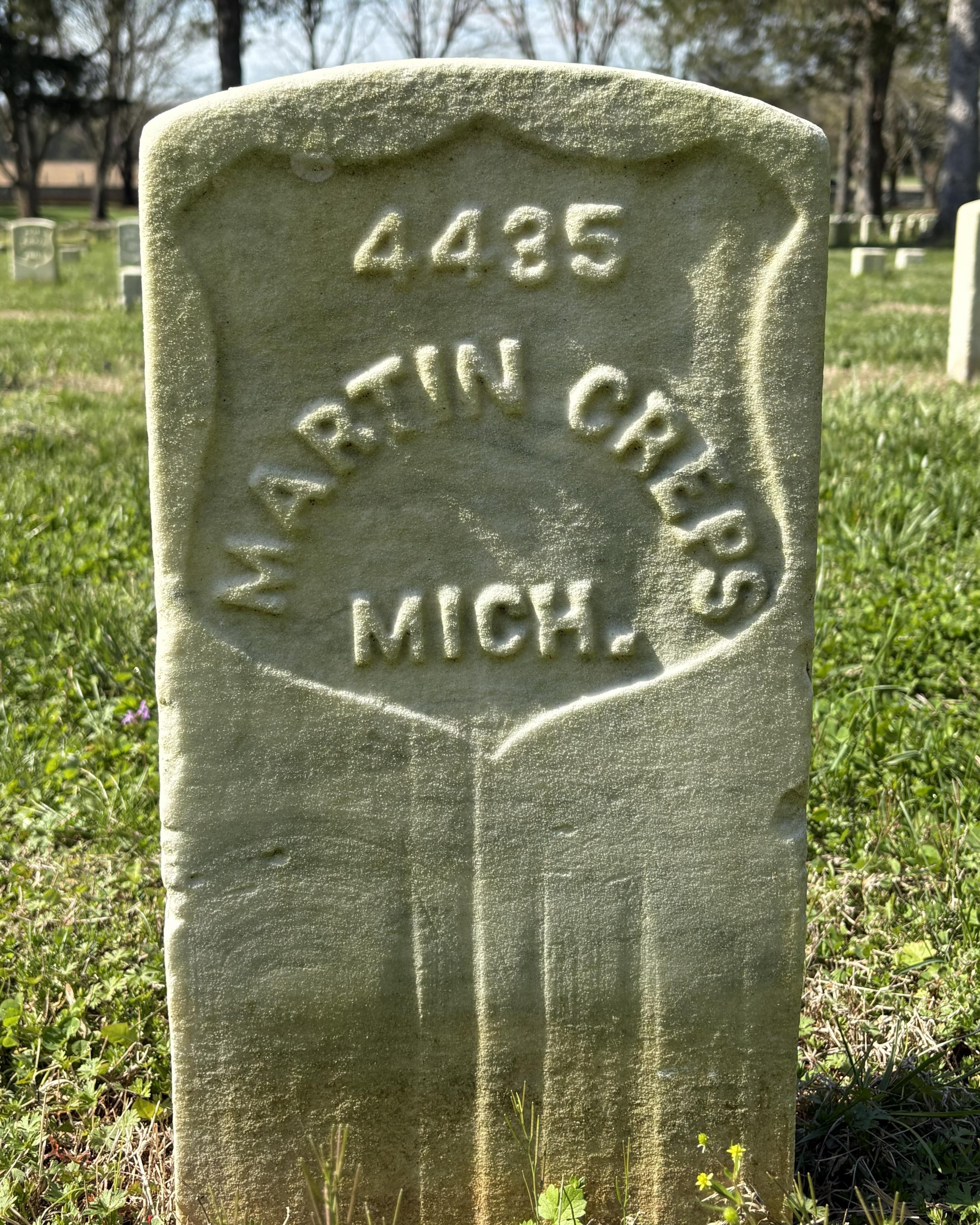 Marble headstone with "Martin Creps MICH." inscribed on it.