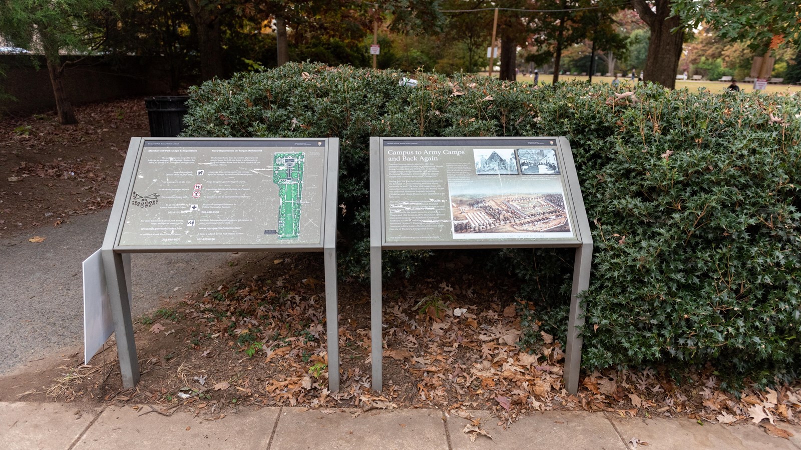 Two informational panels next to a sidewalk.