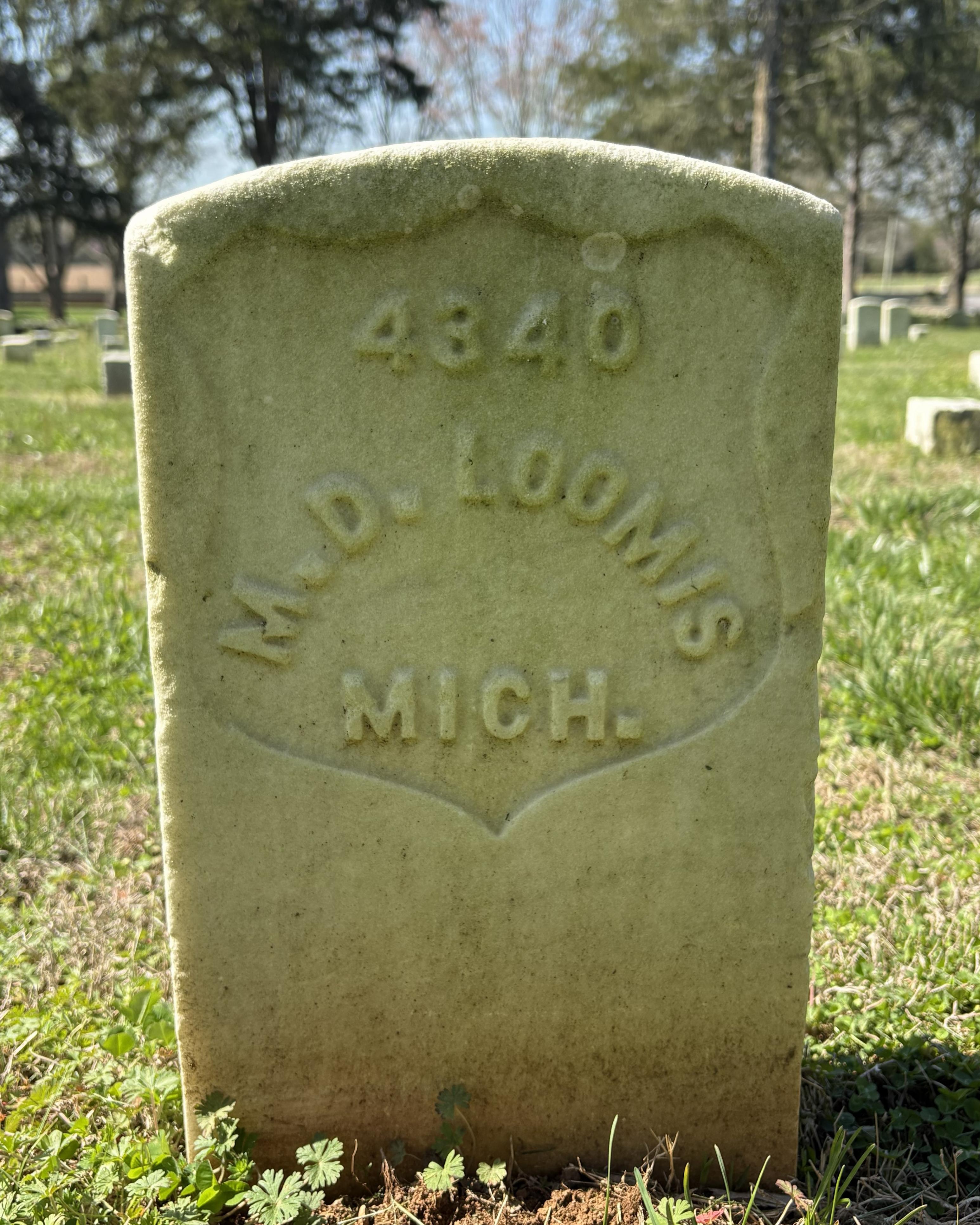 Marble headstone with "M. D. Loomis MICH." inscribed on it.
