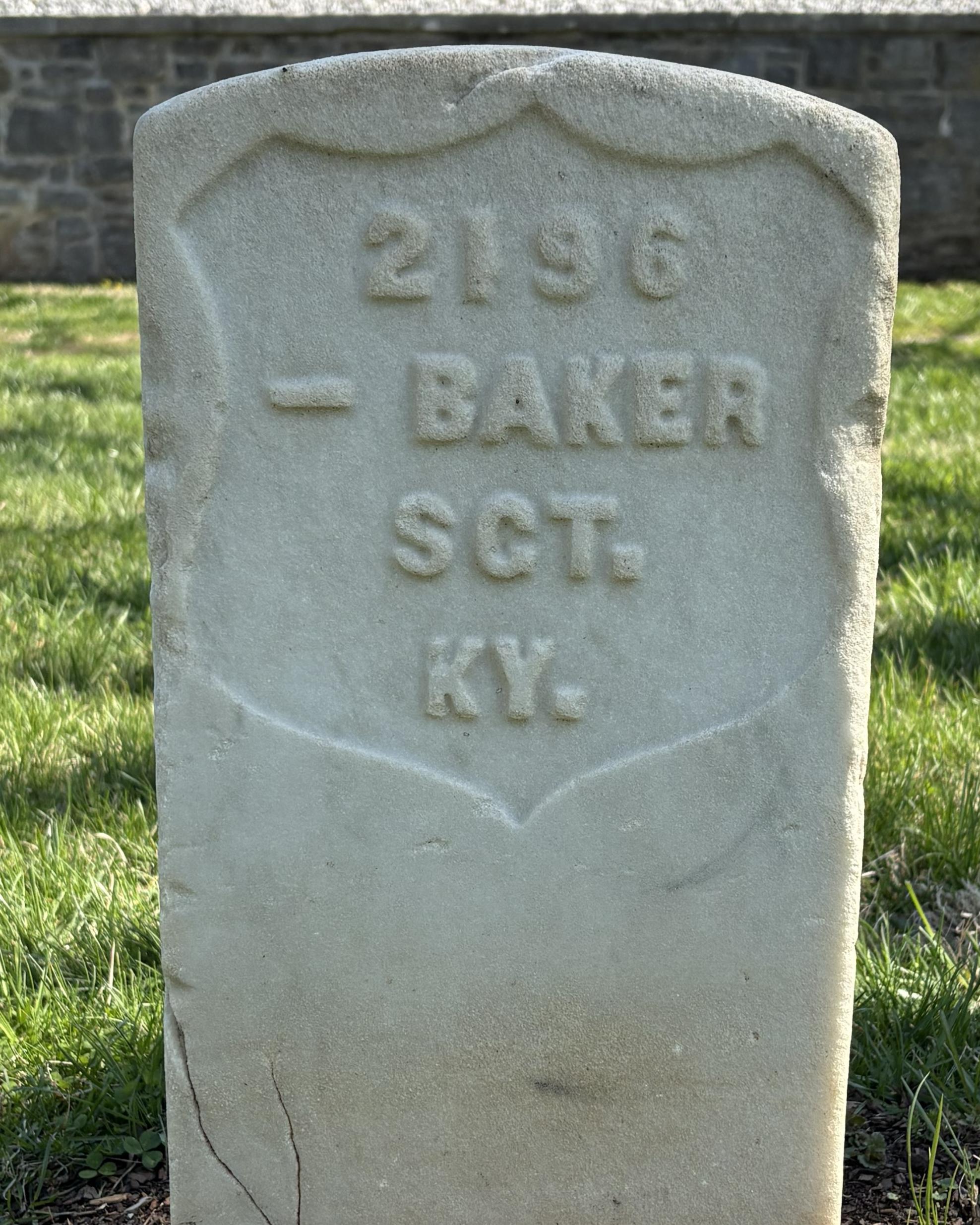 Marble headstone reading "-- Baker SGT. KY." 