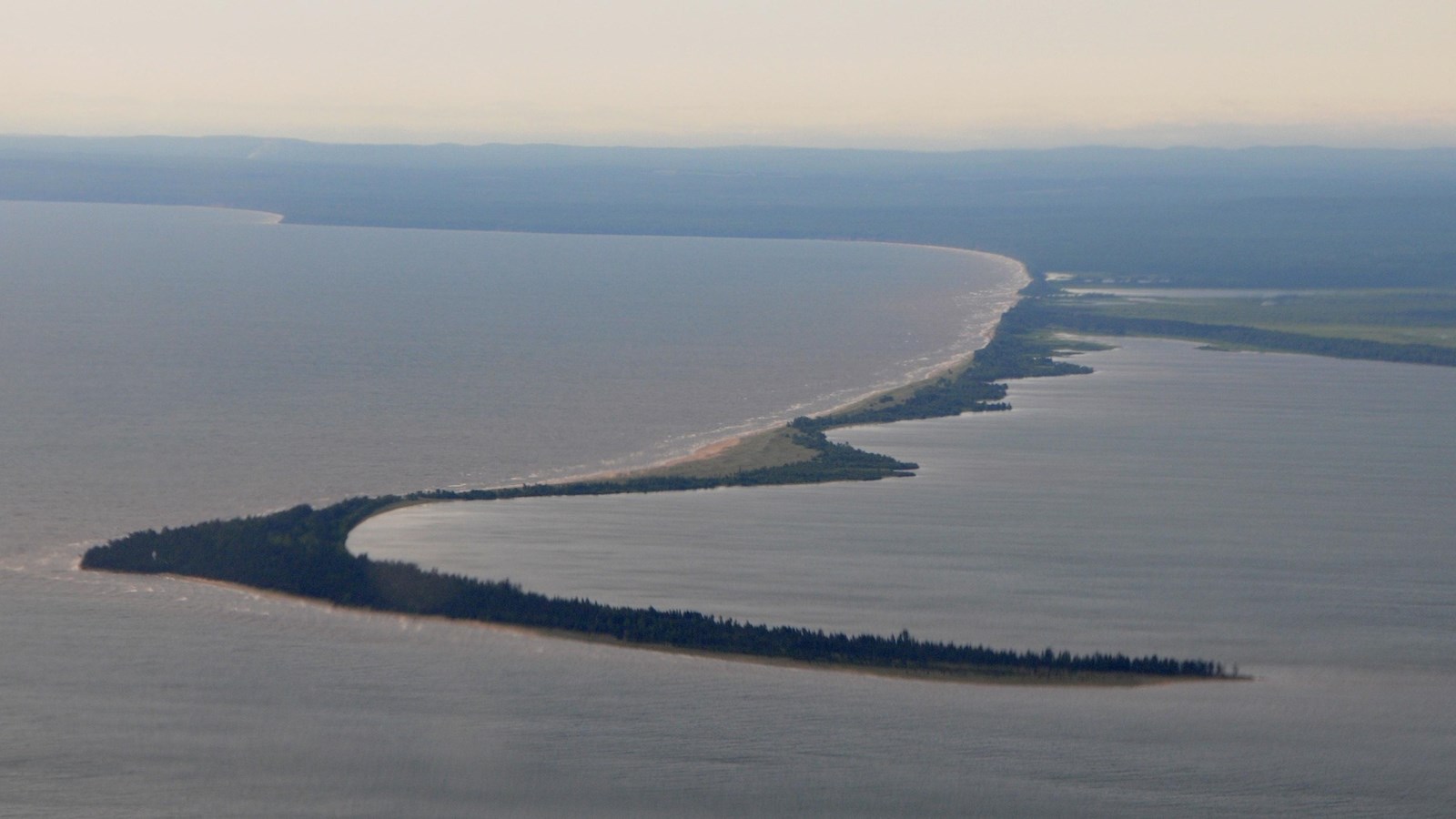 Aerial view of a peninsula surrounded by water and the distant mainland.