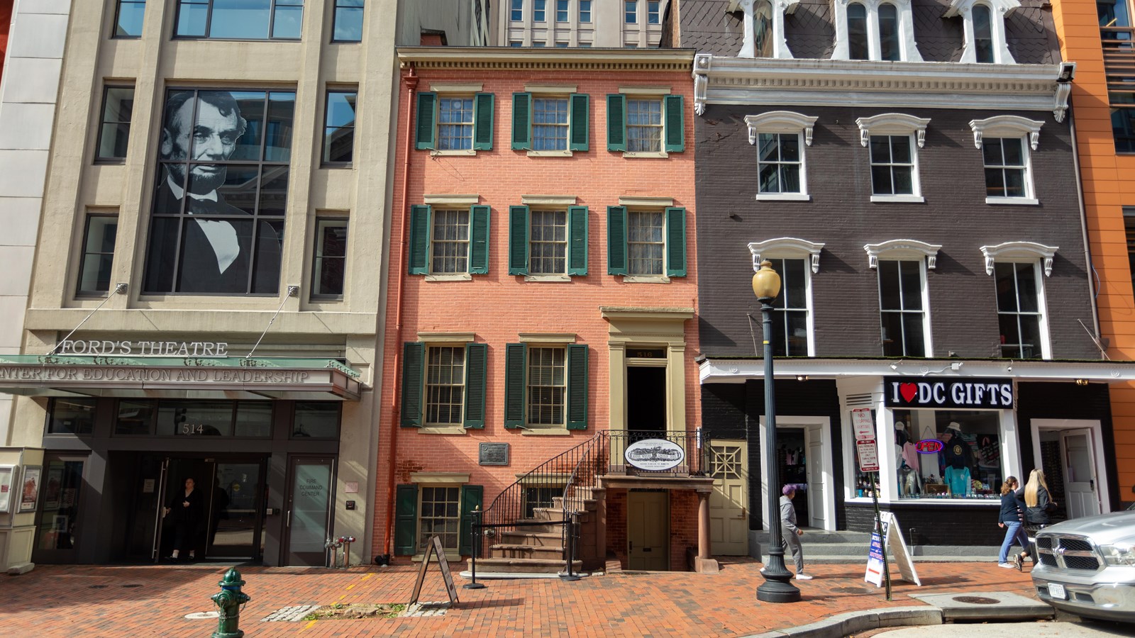 Exterior of three story brick rowhouse.
