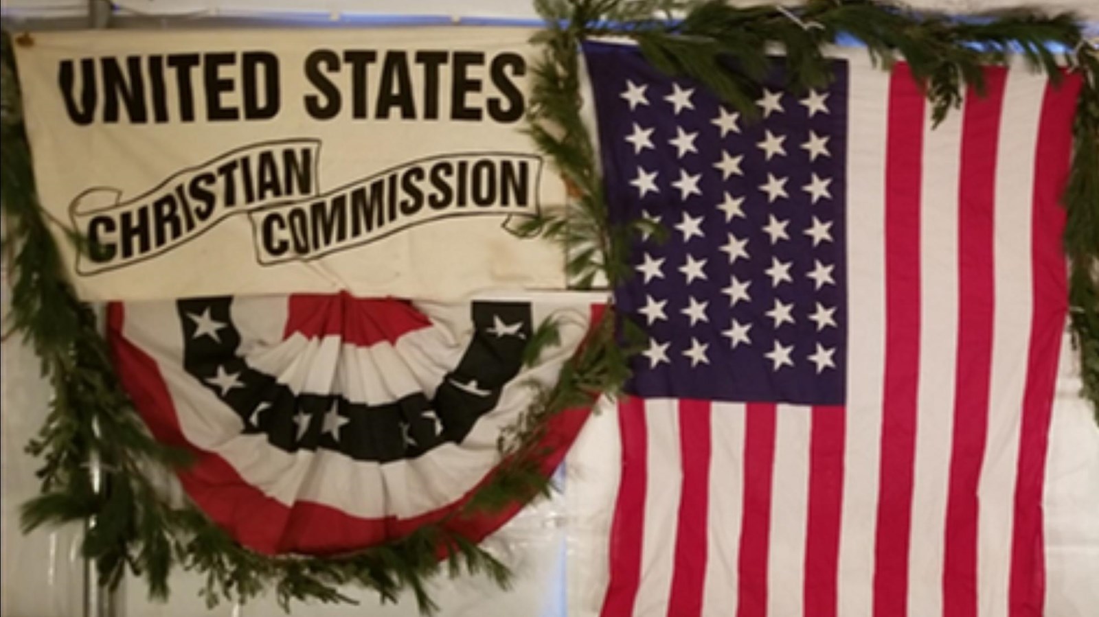 a photo of red, white and blue banners for civil war organizations that donated food and medicine.