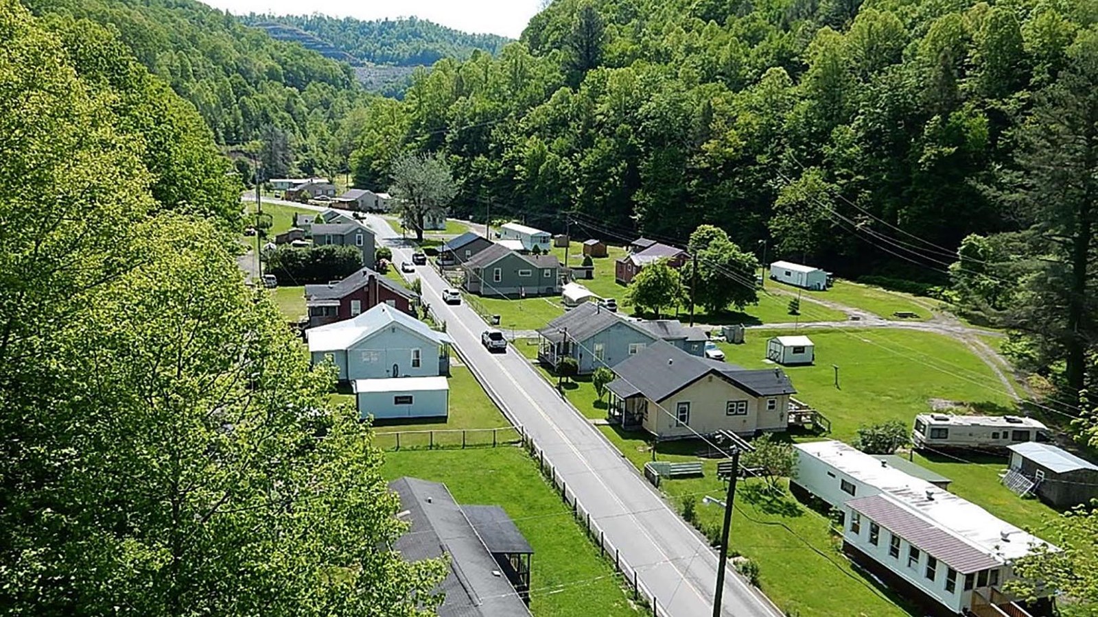 Overhead view of road through small town surrounded by mountains